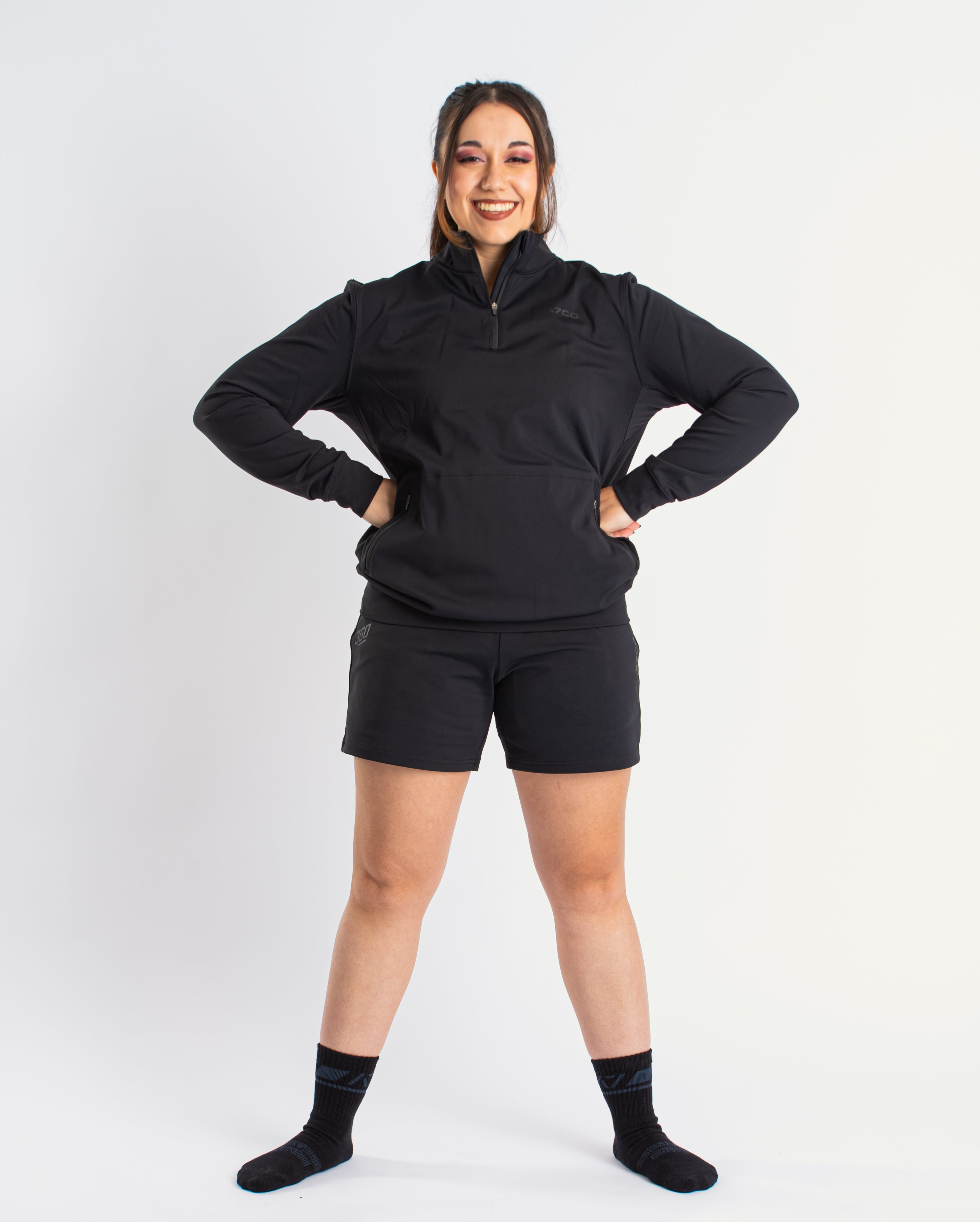 Athlete wearing the A7 Cobra Quarter Zip Jacket in Stealth, demonstrating fit and style in a gym setting.