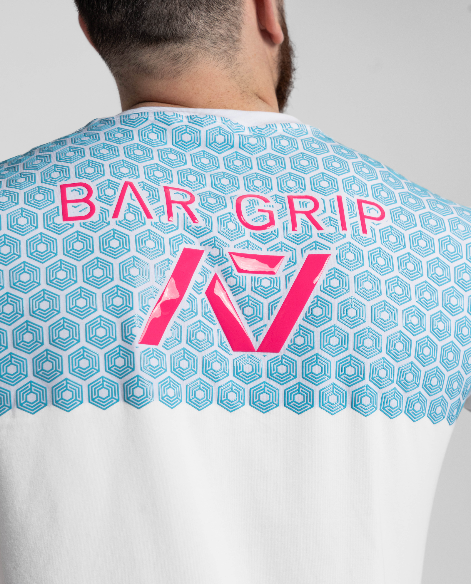 Close up of pink and blue bar grip on code shirt