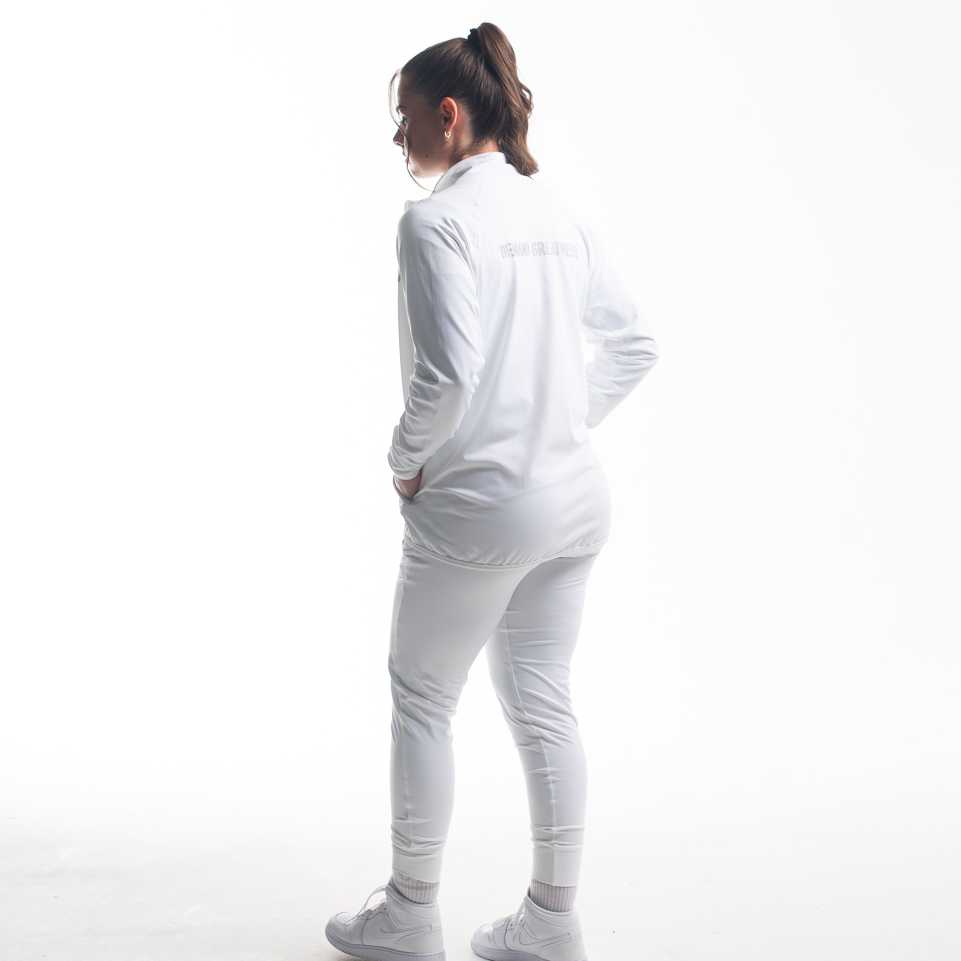 Full back view of athlete wearing the Defy Jacket – Polar, showcasing the streamlined panel design, tapered fit, and smooth stretch fabric from shoulders to hem.