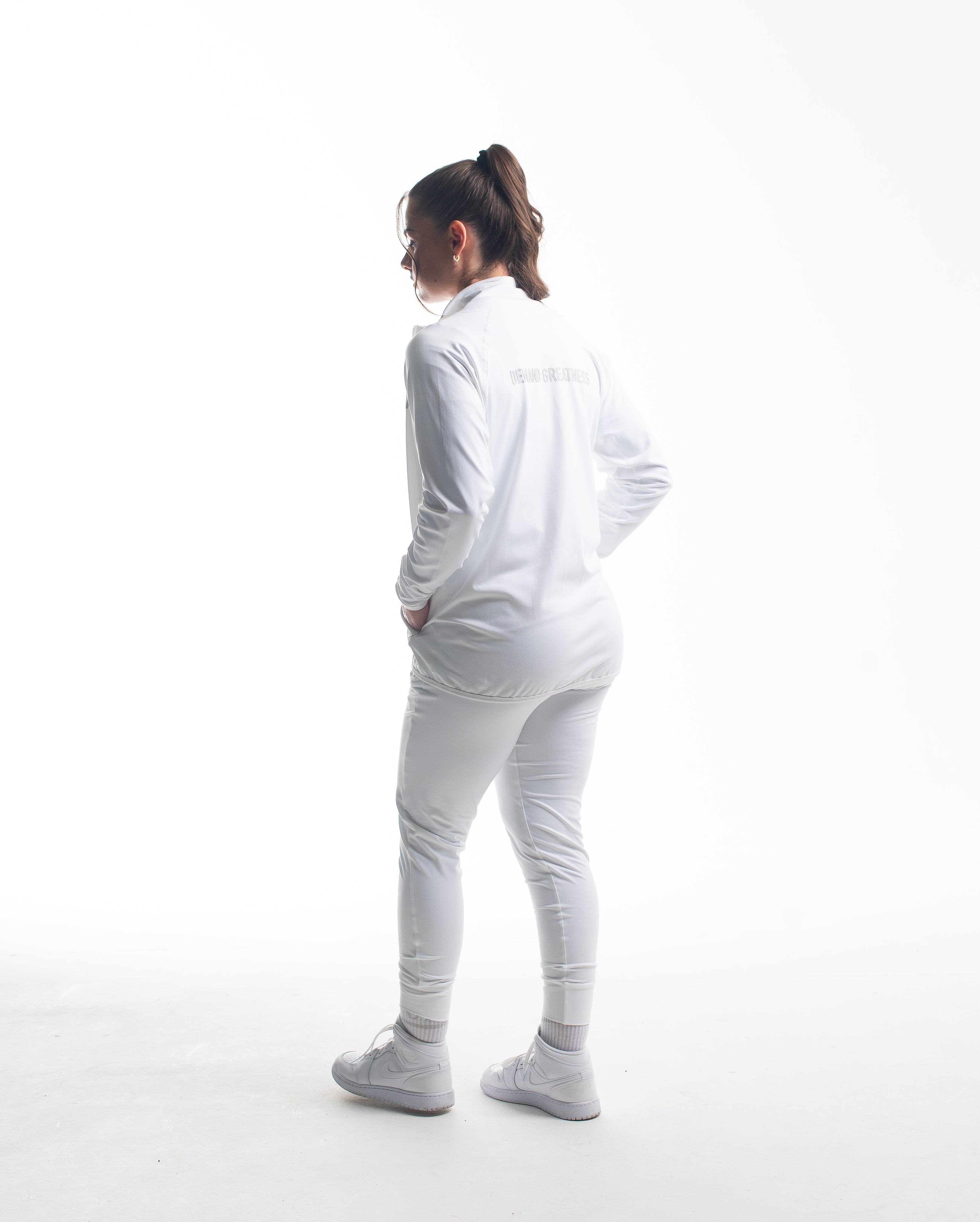 Full back view of athlete wearing the Defy Jacket – Polar, showcasing the streamlined panel design, tapered fit, and smooth stretch fabric from shoulders to hem.