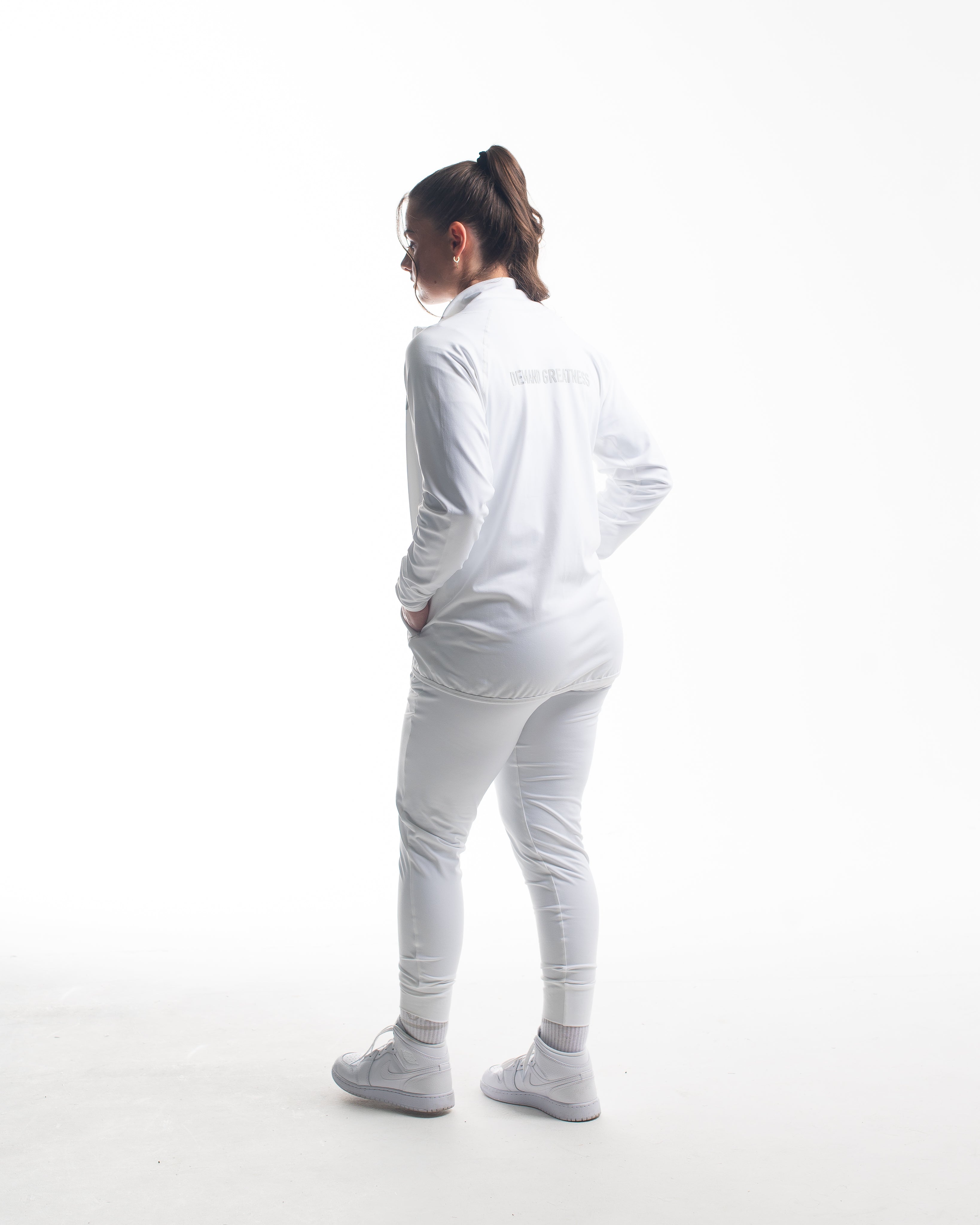 Full back view of athlete wearing the Defy Jacket – Polar, showcasing the streamlined panel design, tapered fit, and smooth stretch fabric from shoulders to hem.