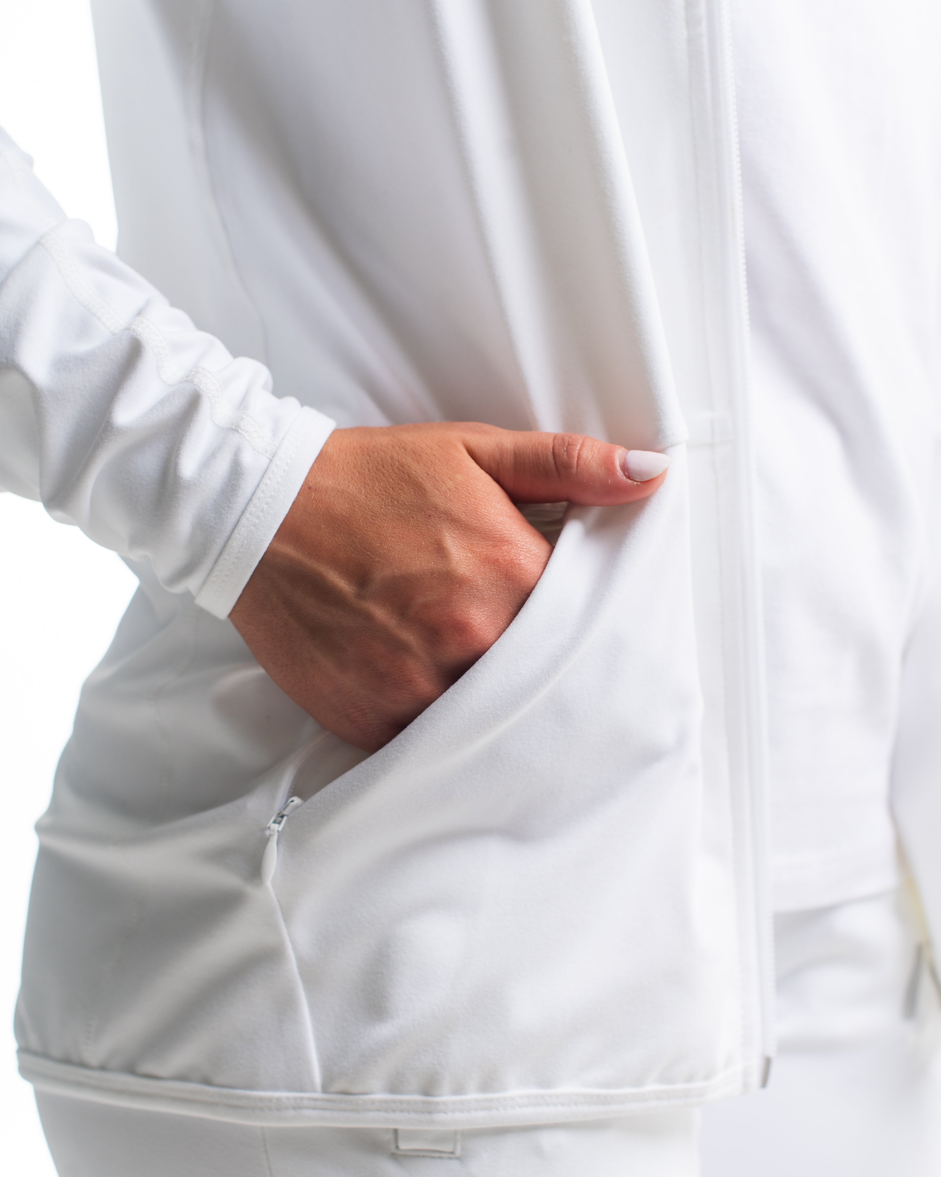 Close-up of the secure side zip pocket on the Defy Jacket – Polar, accented with stretch knit.