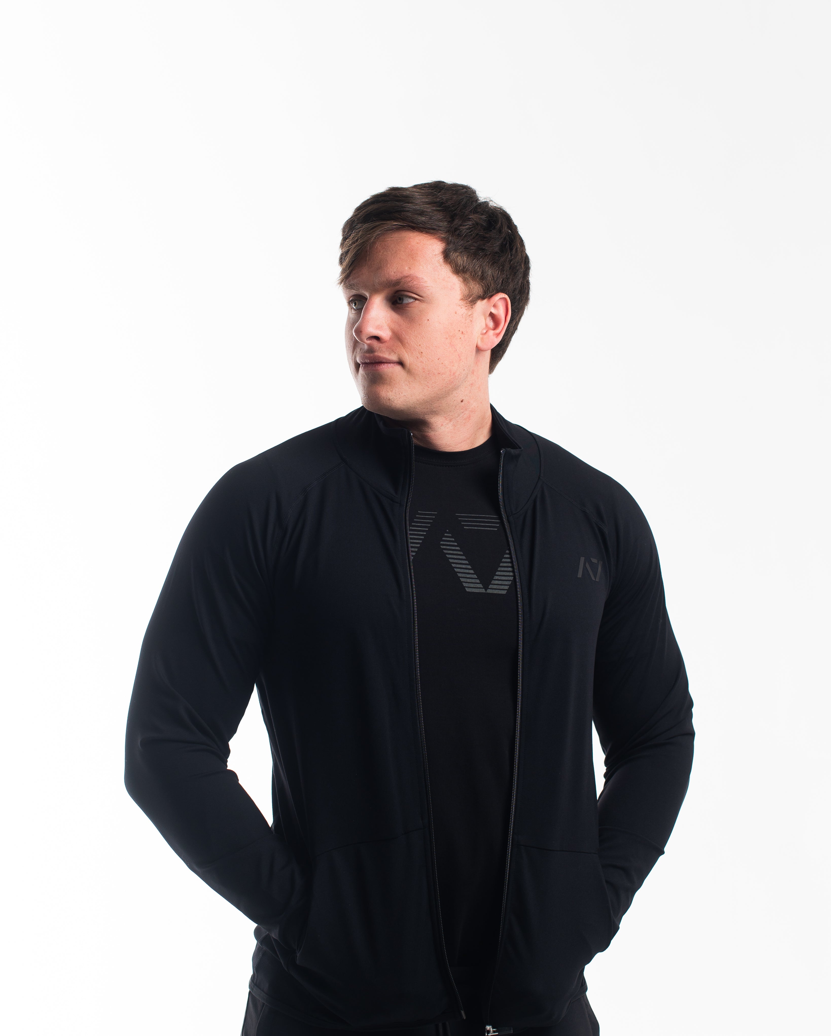 Front view of the A7 Defy Jacket – Stealth, showing clean unisex fit and front zipper design.