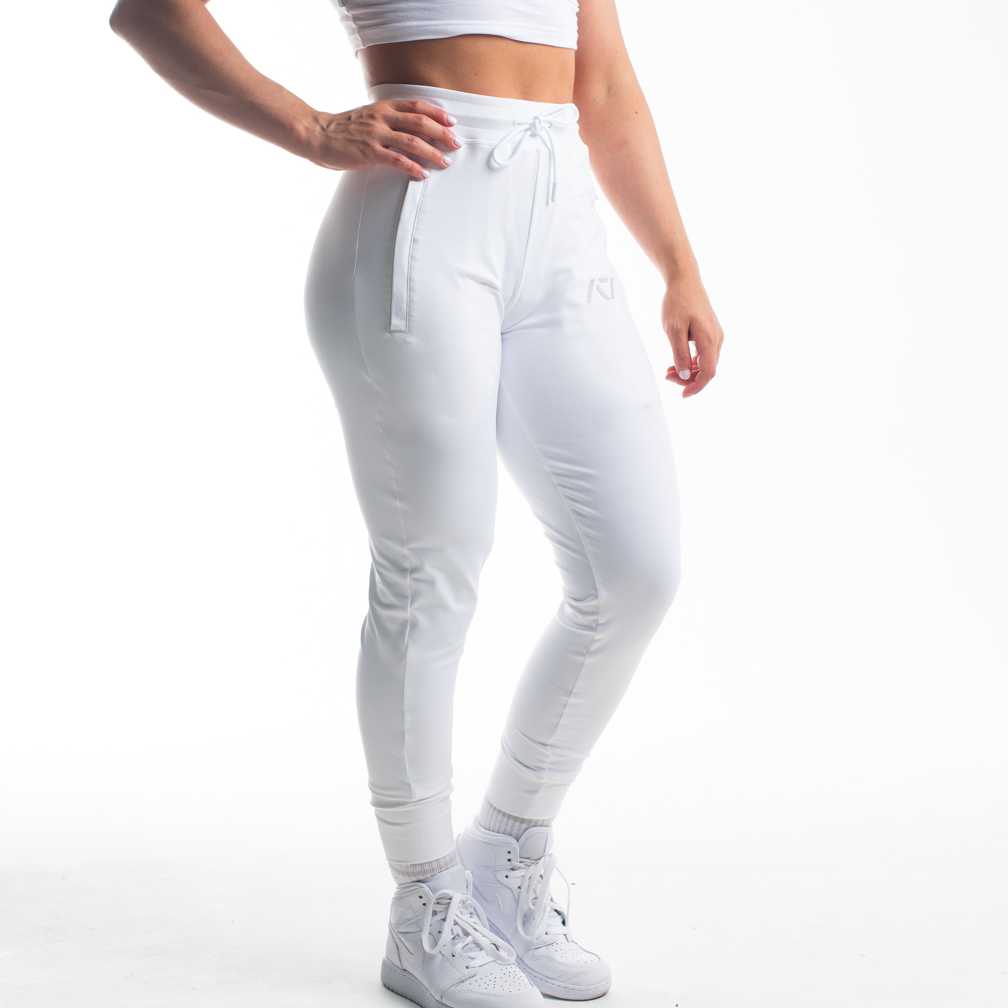 Front view of Polar Defy Joggers showing mid-rise waist, tapered legs, and zippered front pockets.