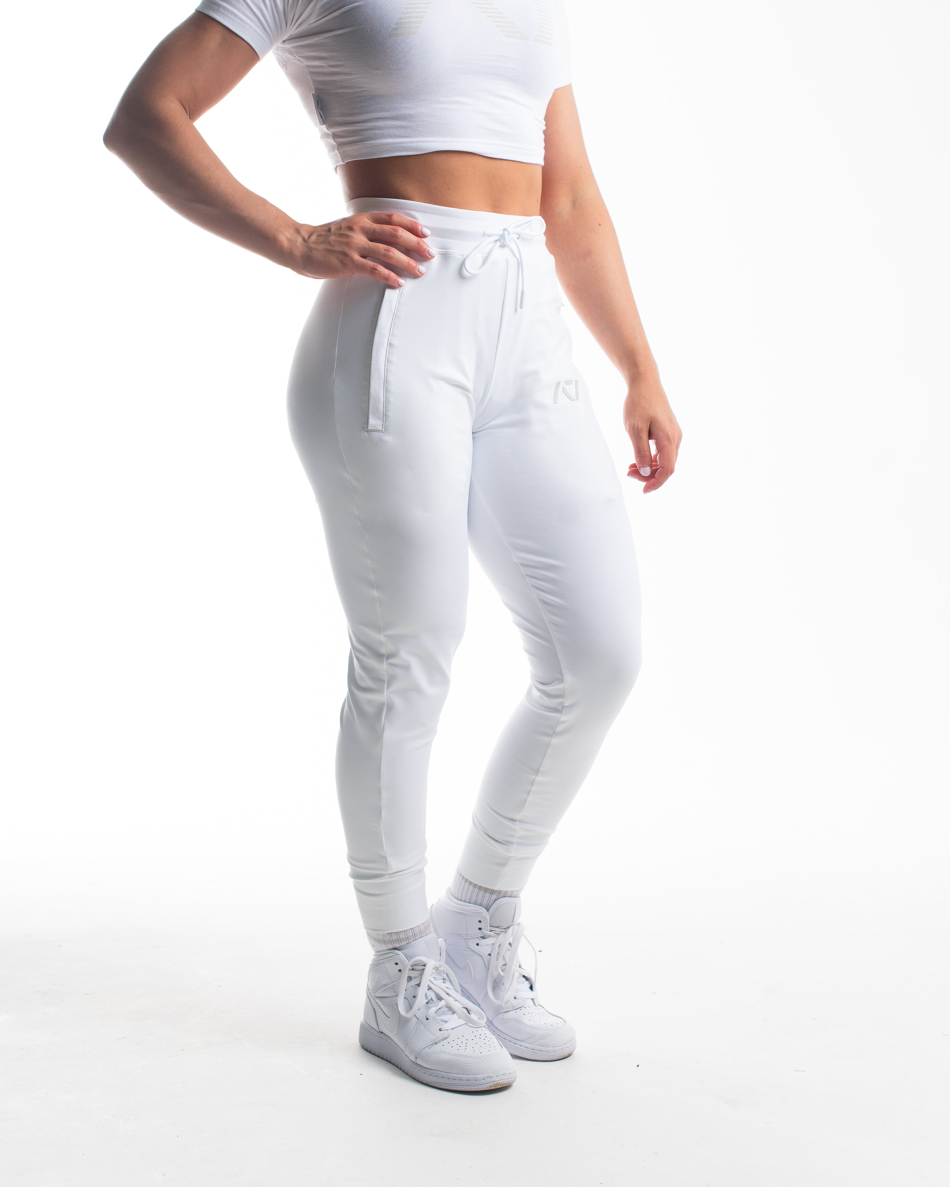 Front view of Polar Defy Joggers showing mid-rise waist, tapered legs, and zippered front pockets.