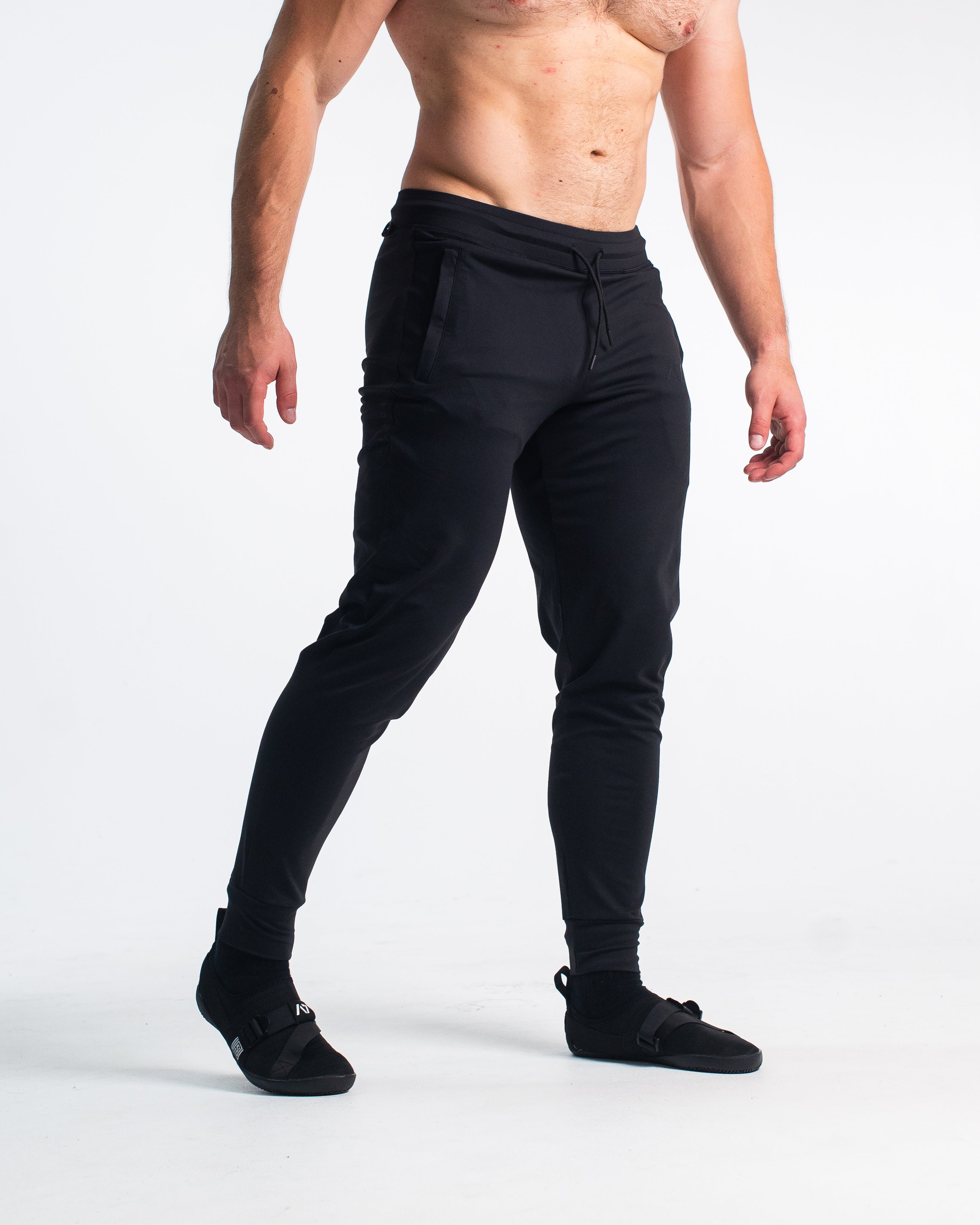 Front view of Stealth Defy Joggers showing tapered leg, mid-rise waist, and zippered front pockets.