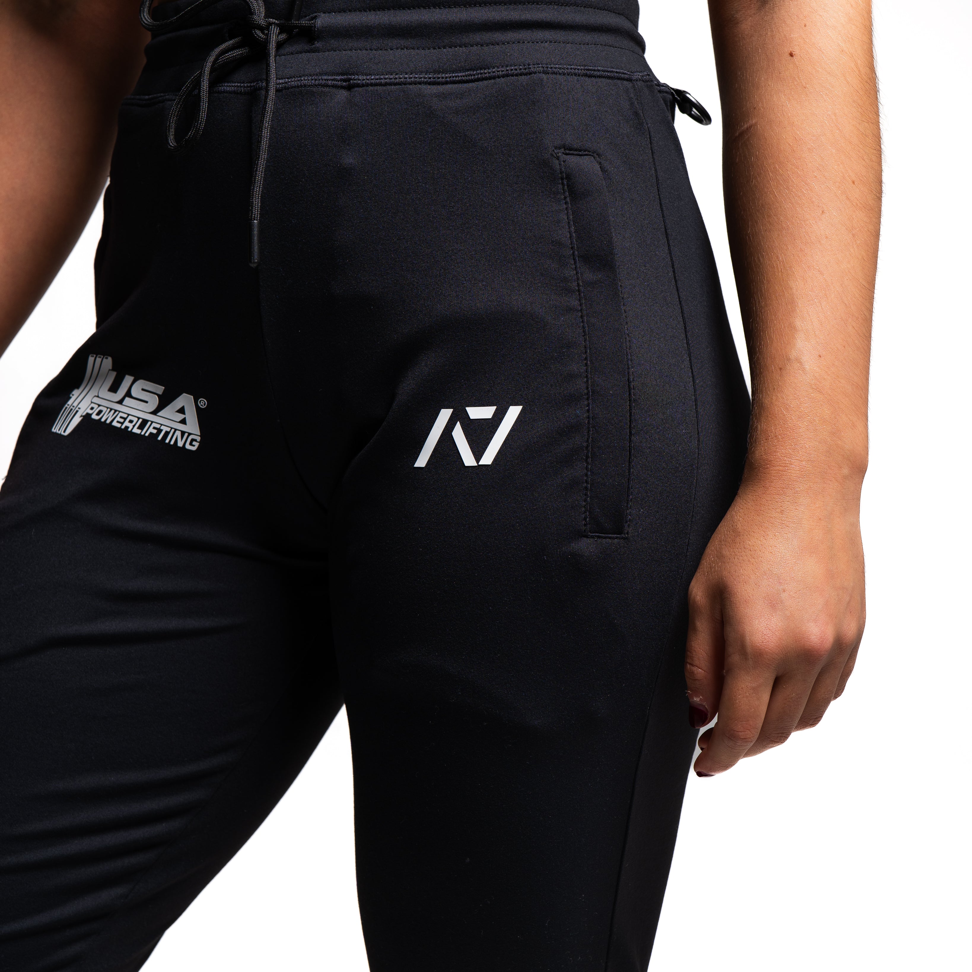 Close-up of the USAPL and A7 silicone logos printed on the front thigh of the joggers.