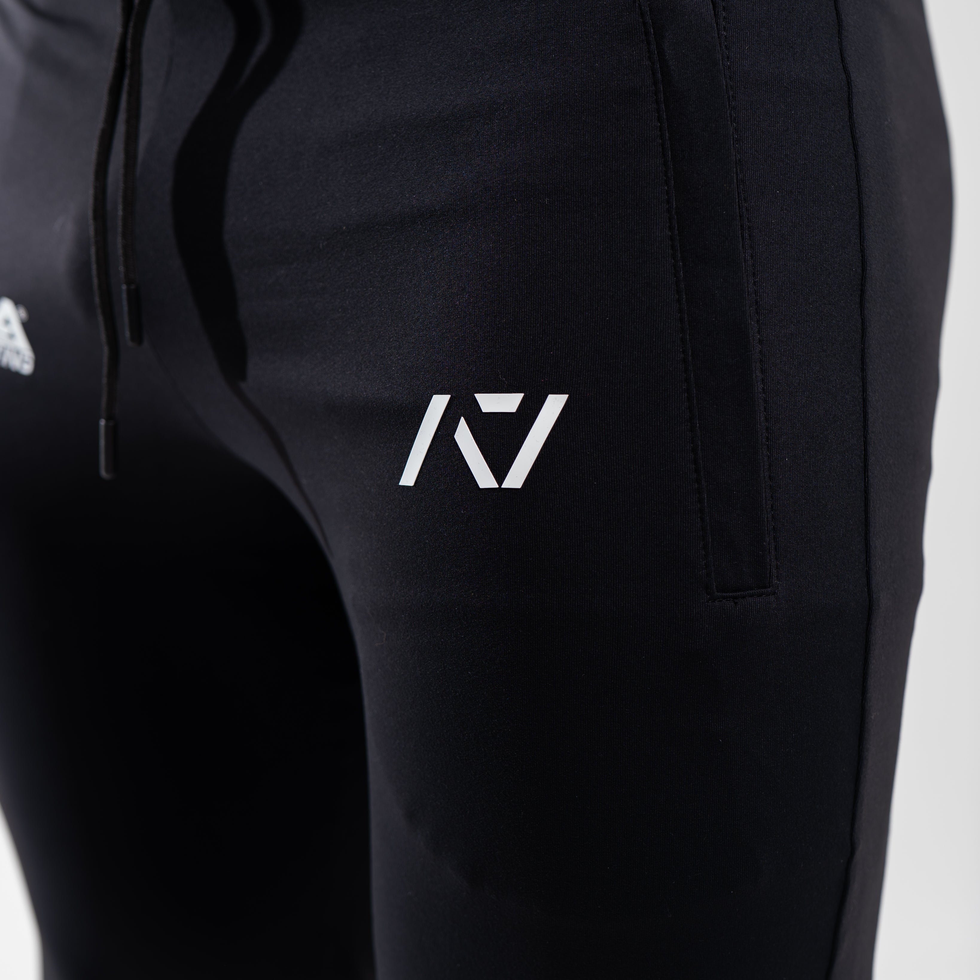 Close-up of the USAPL and A7 silicone logos printed on the front thigh of the joggers.
