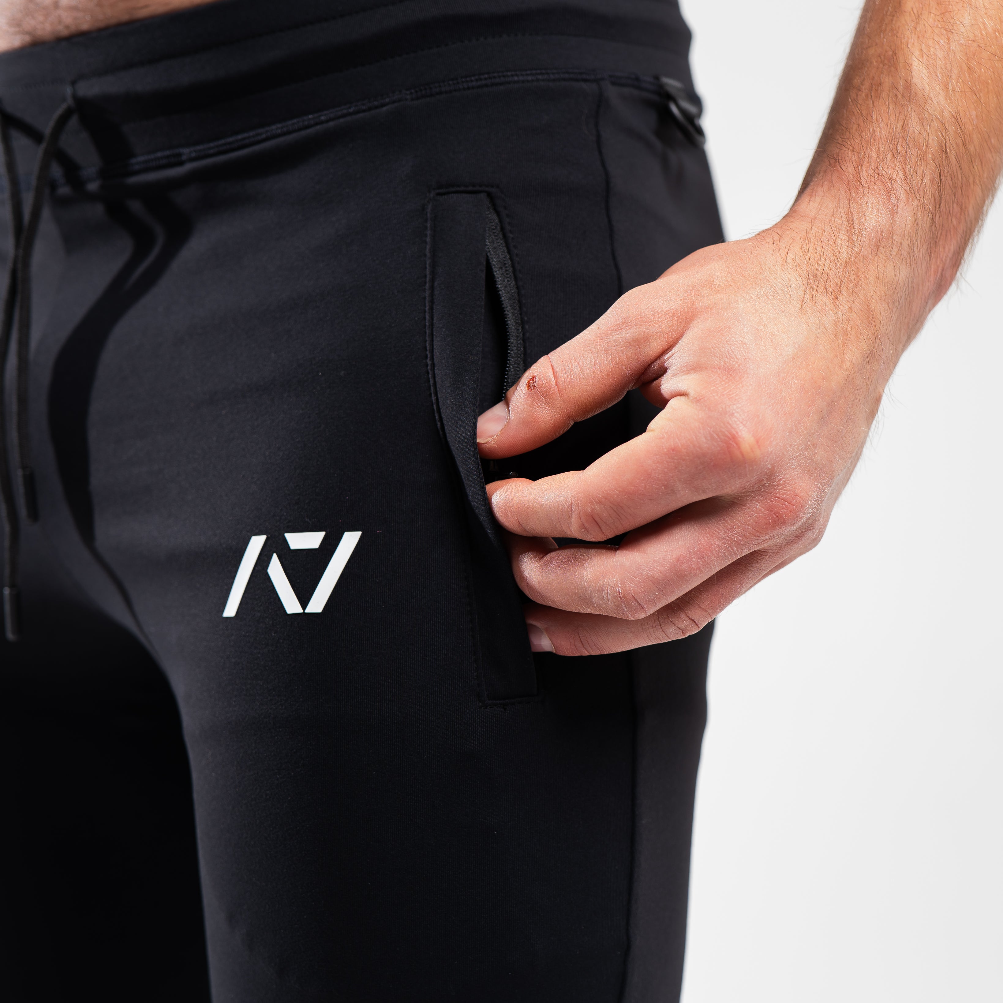 Close-up of front zippered pocket and moisture-wicking stretch fabric.