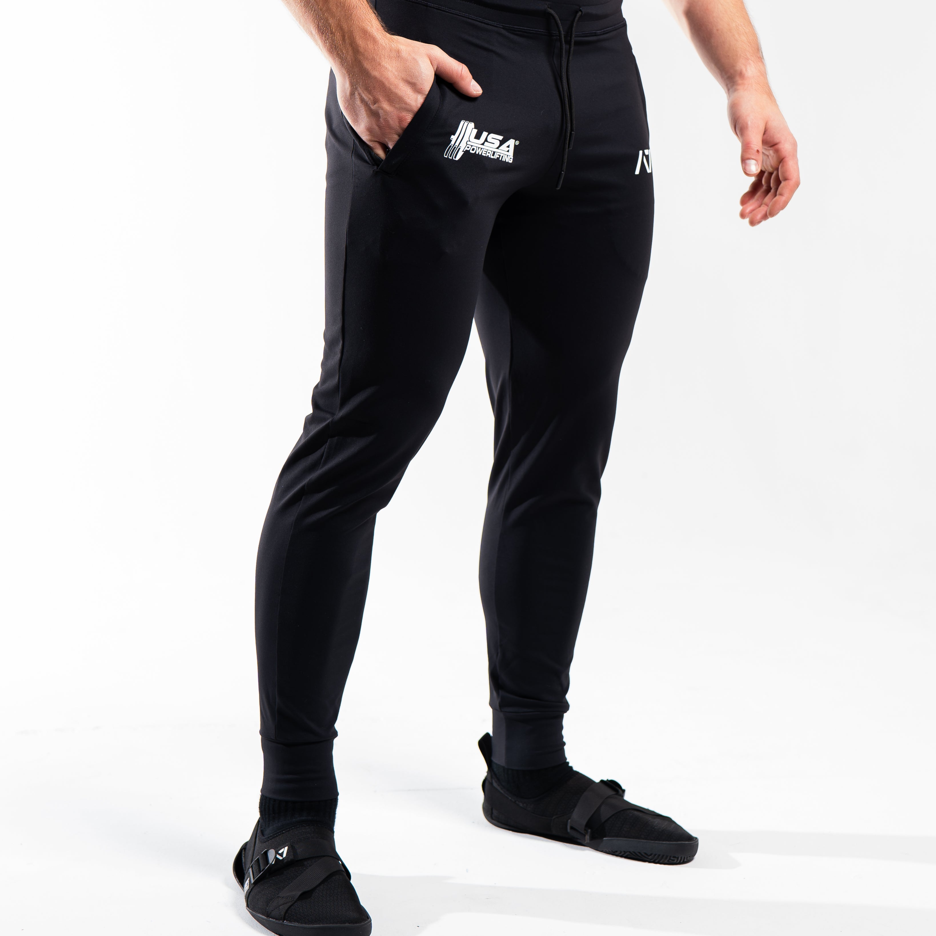 Side profile of the USAPL Classic joggers highlighting the tapered leg and silicone logo print.