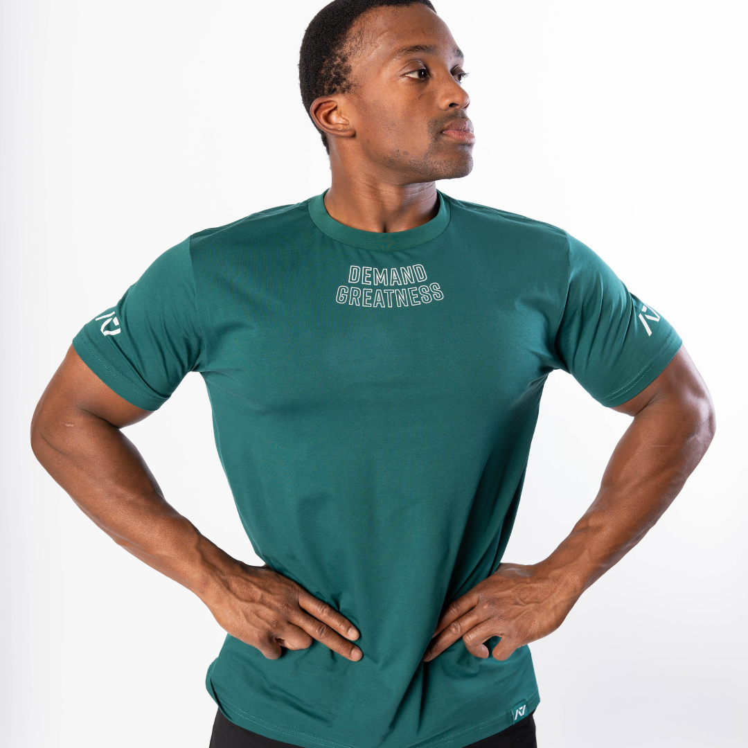 Front view of the Emerald Forás True‑Fit Meet Shirt showing “Demand Greatness” chest print and trimmed fit.