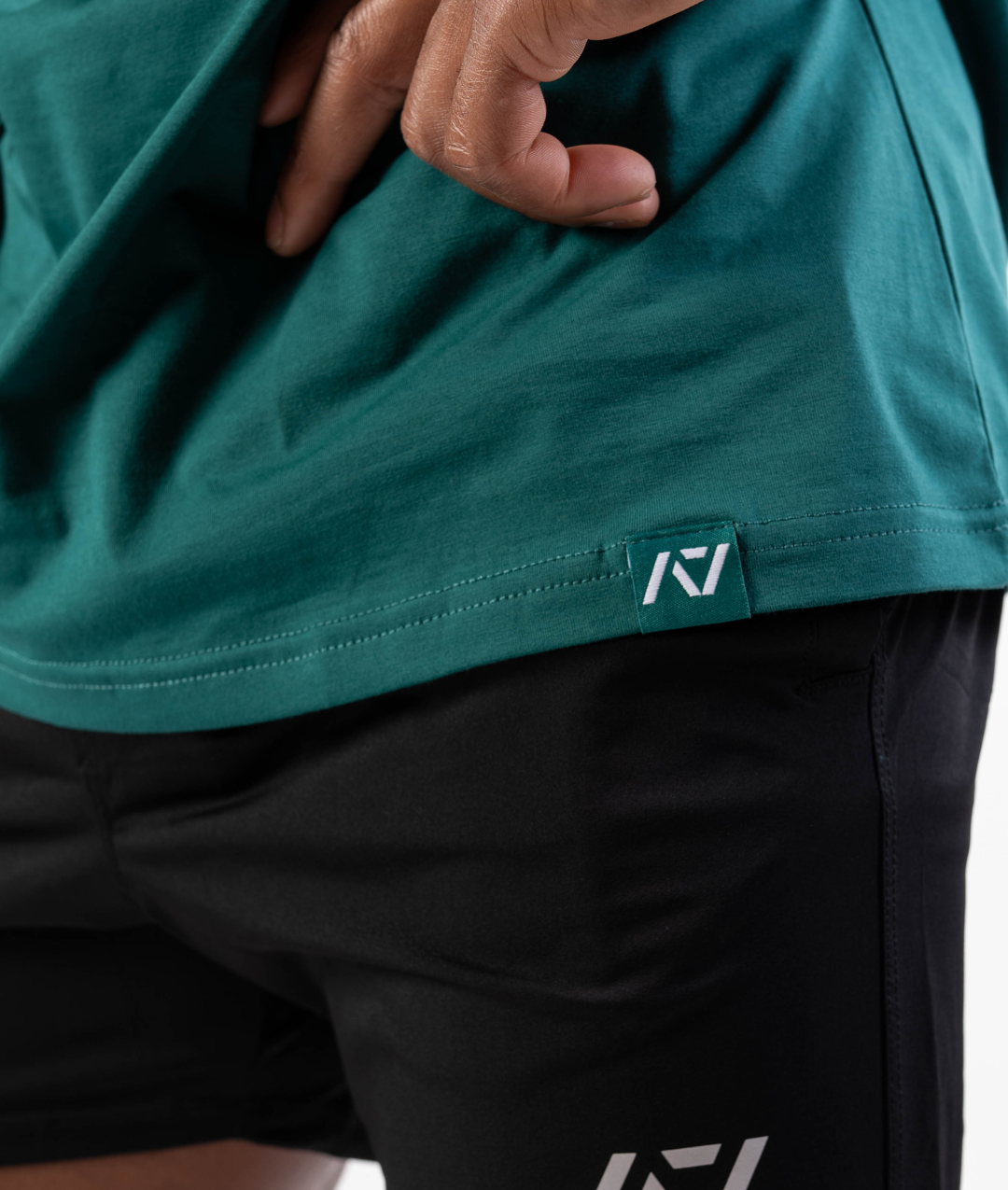 Close-up of woven A7 hem tag along the bottom hem of the shirt.