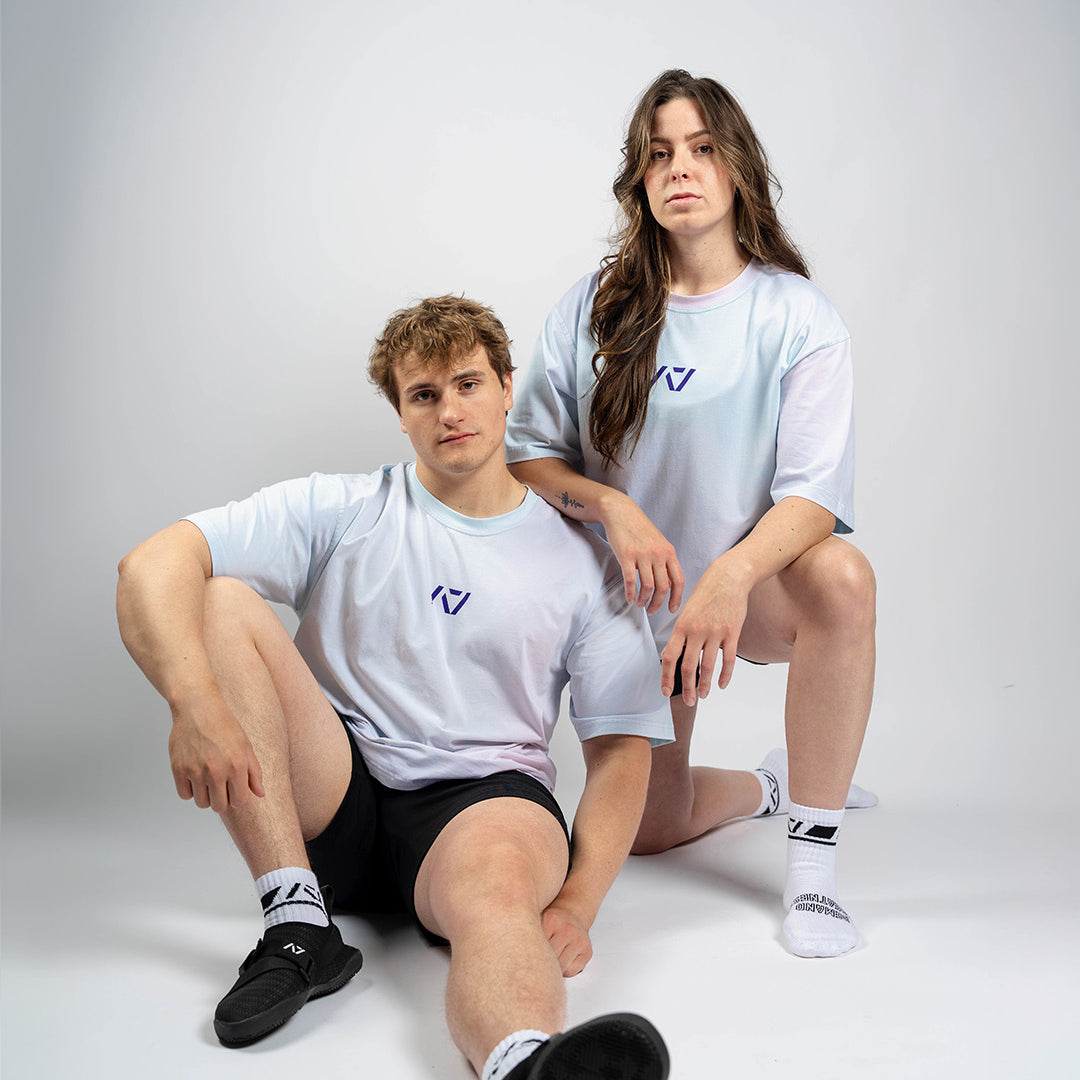 Male and female models wearing the A7 Affirmation Over-Fit Shirt – Pastel, demonstrating unisex oversized fit across body types.