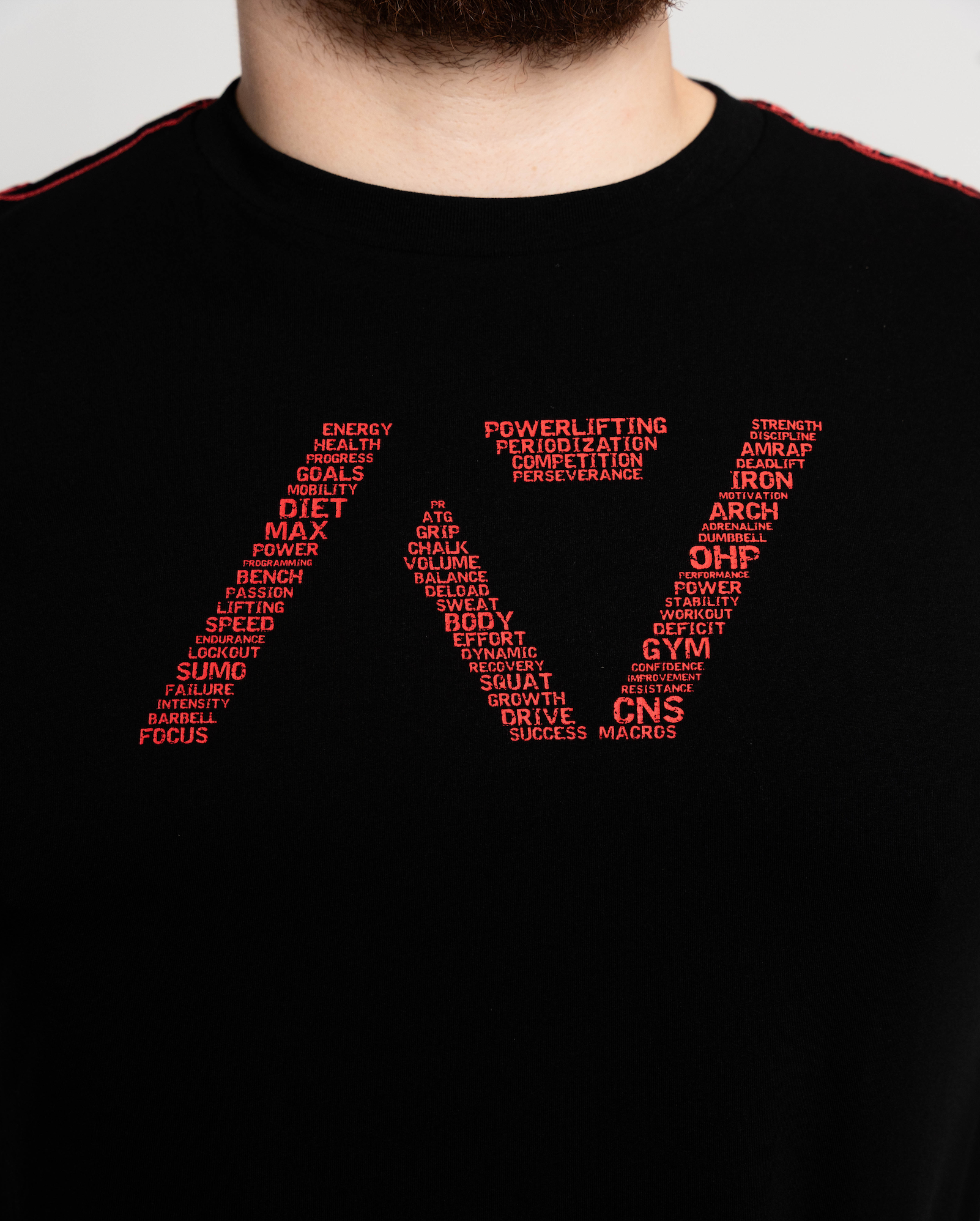 Black t-shirt with red text design on a plain background