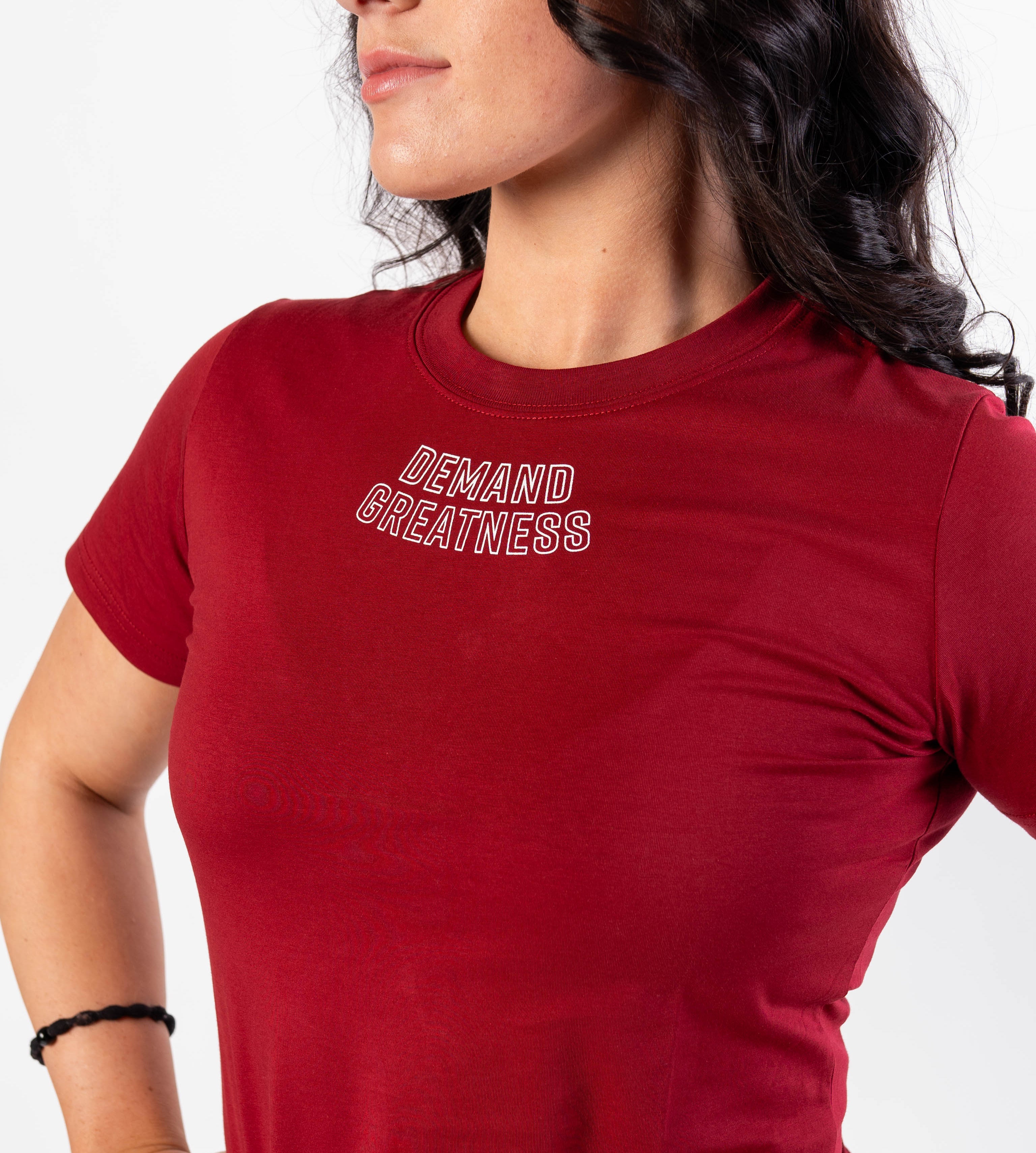 Close up of DEMAND GREATNESS text on the top of center chest of meet shirt to show underneath singlet