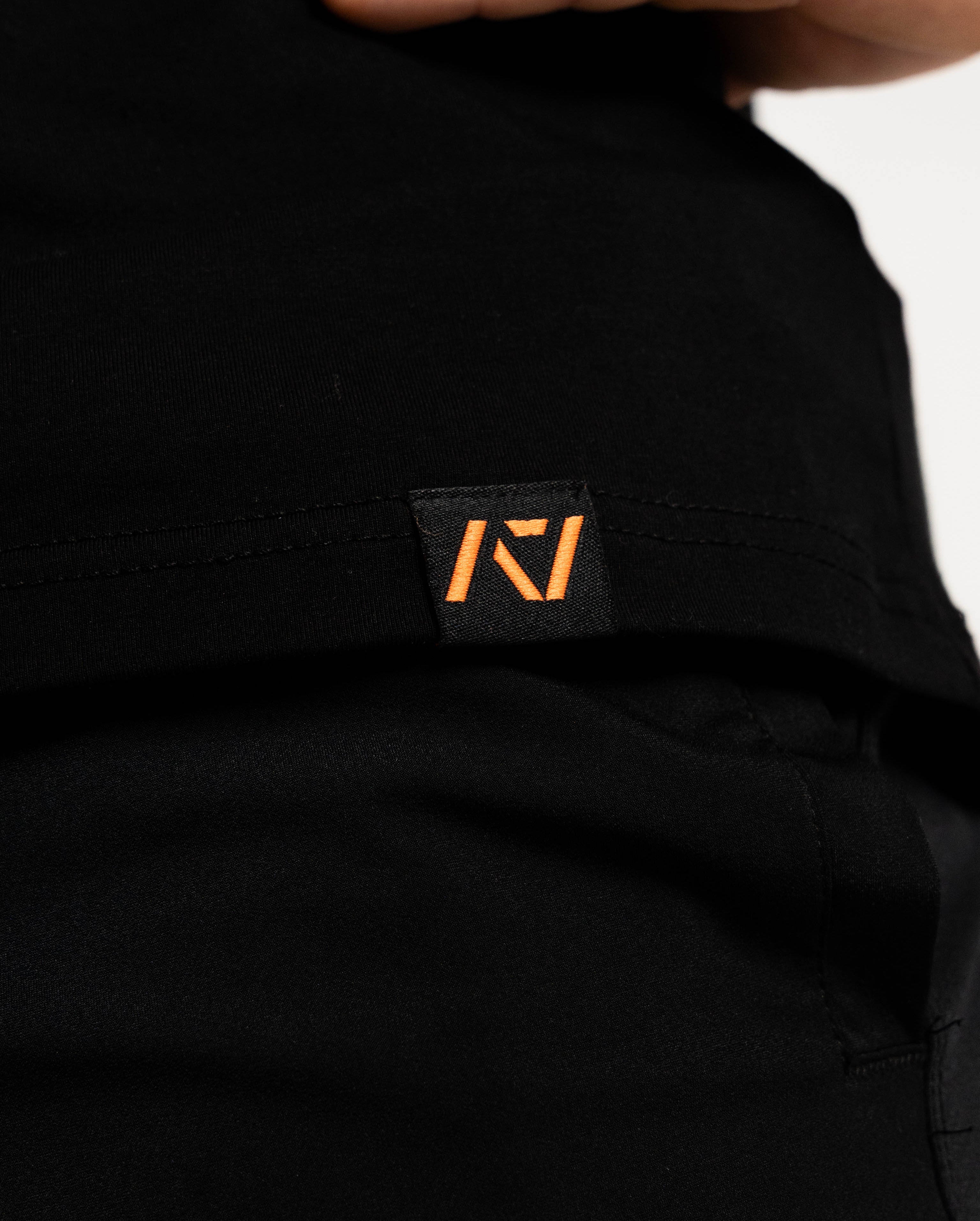 Hem tag with A7 logo on the stronger than before men's bar grip shirt