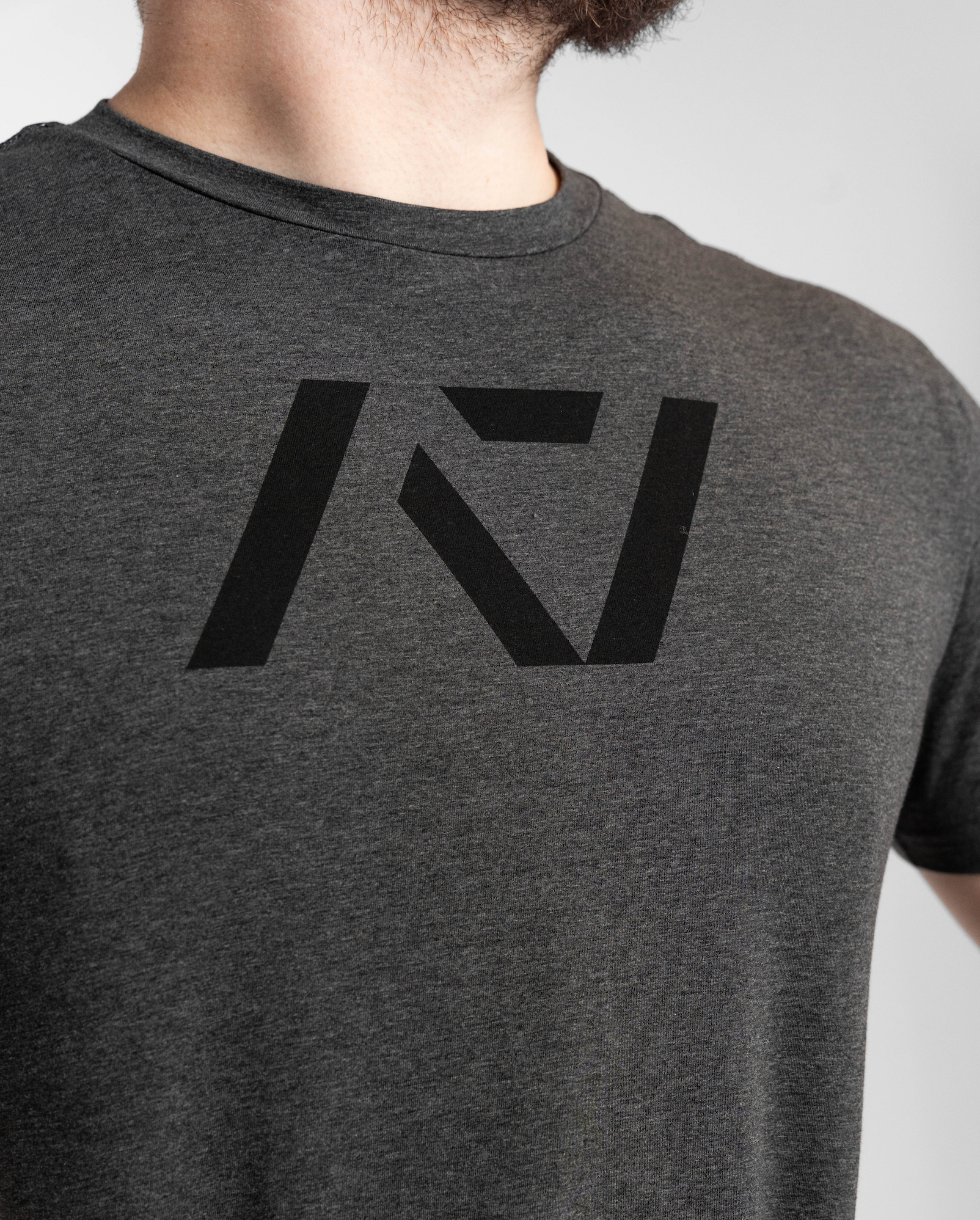 Gray t-shirt with a black logo on a plain background