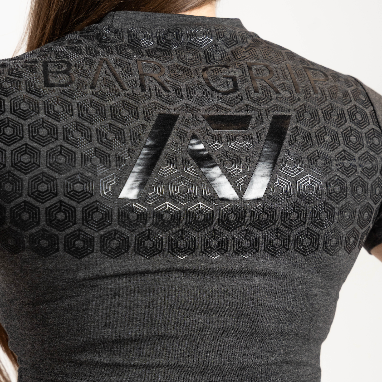 Black crop top with a7 bar grip and branding on a white background