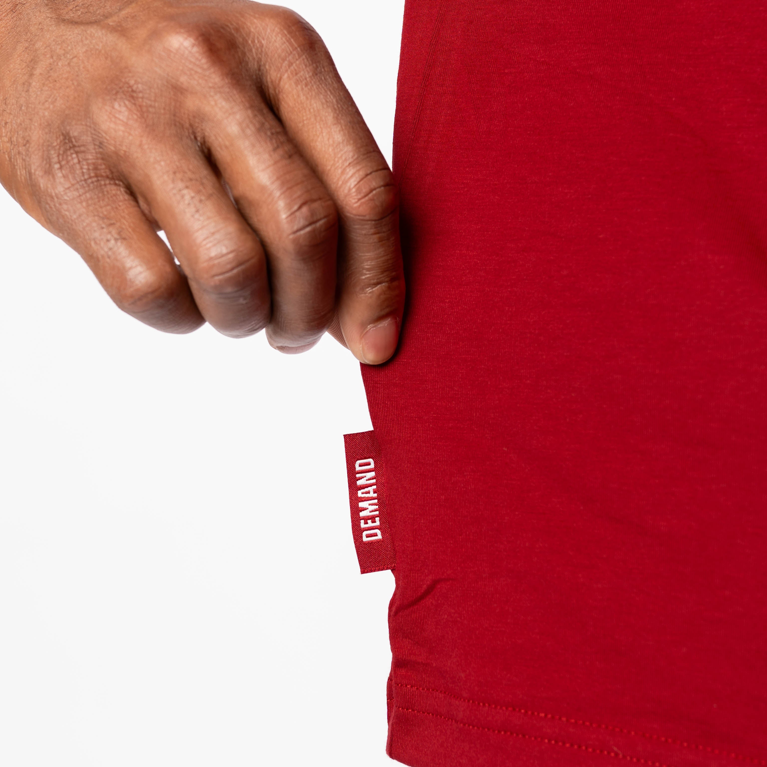 Close up of Demand Greatness side hem tag