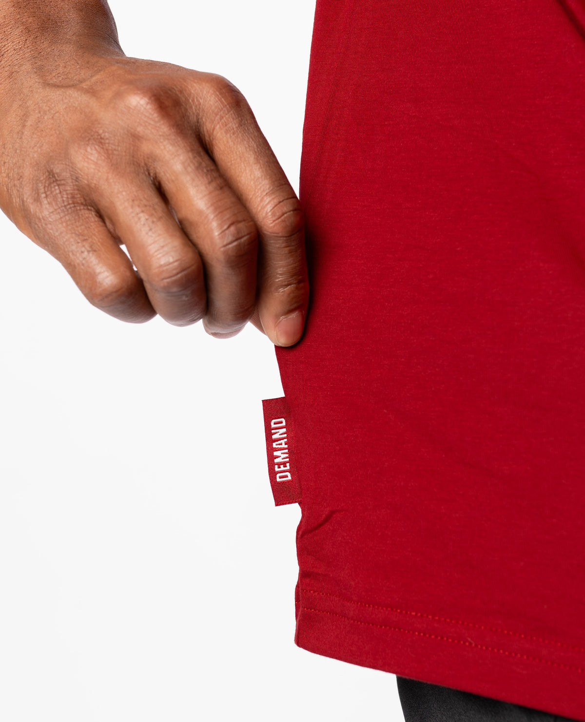 Close up of Demand Greatness side hem tag