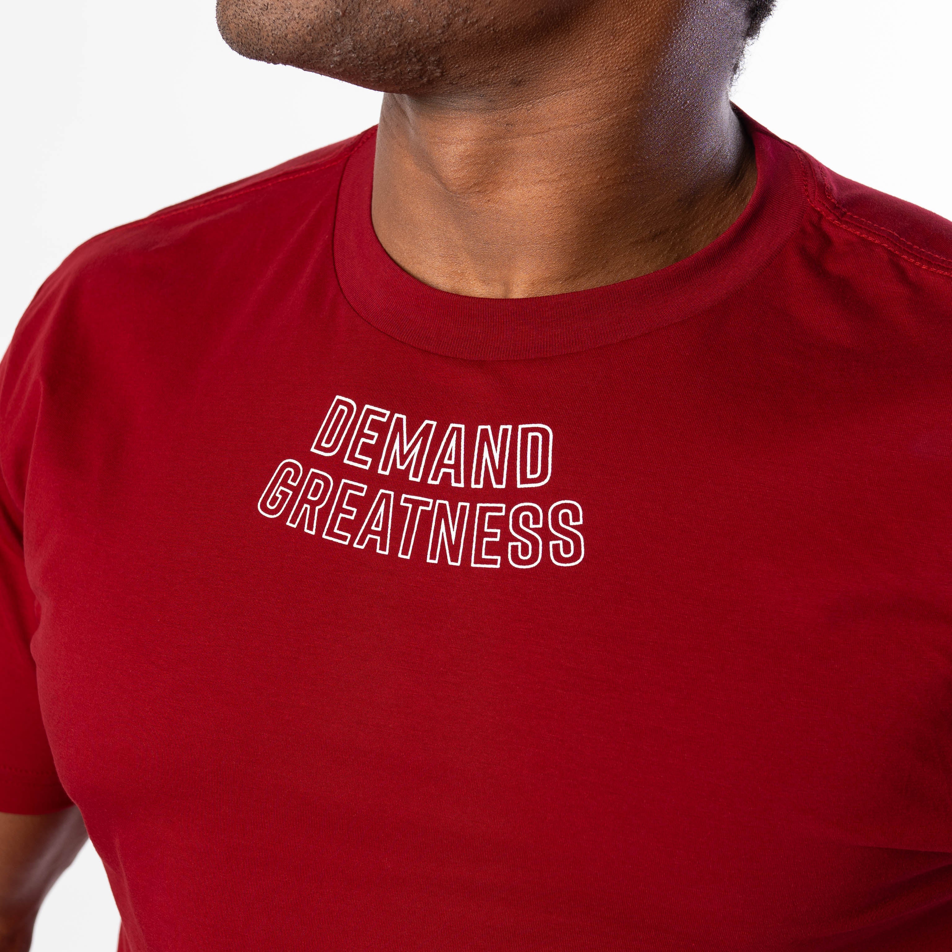 Close up of DEMAND GREATNESS text on the upper center chest of A7 meet shirt in red