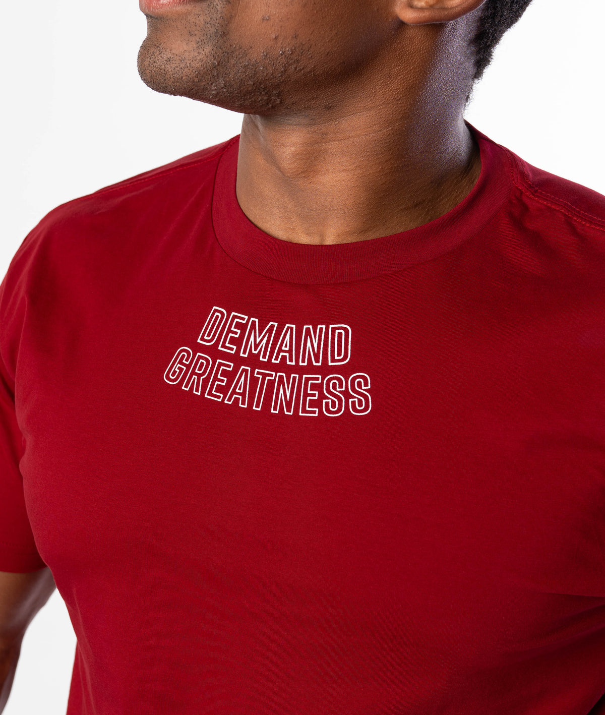 Close up of DEMAND GREATNESS text on the upper center chest of A7 meet shirt in red