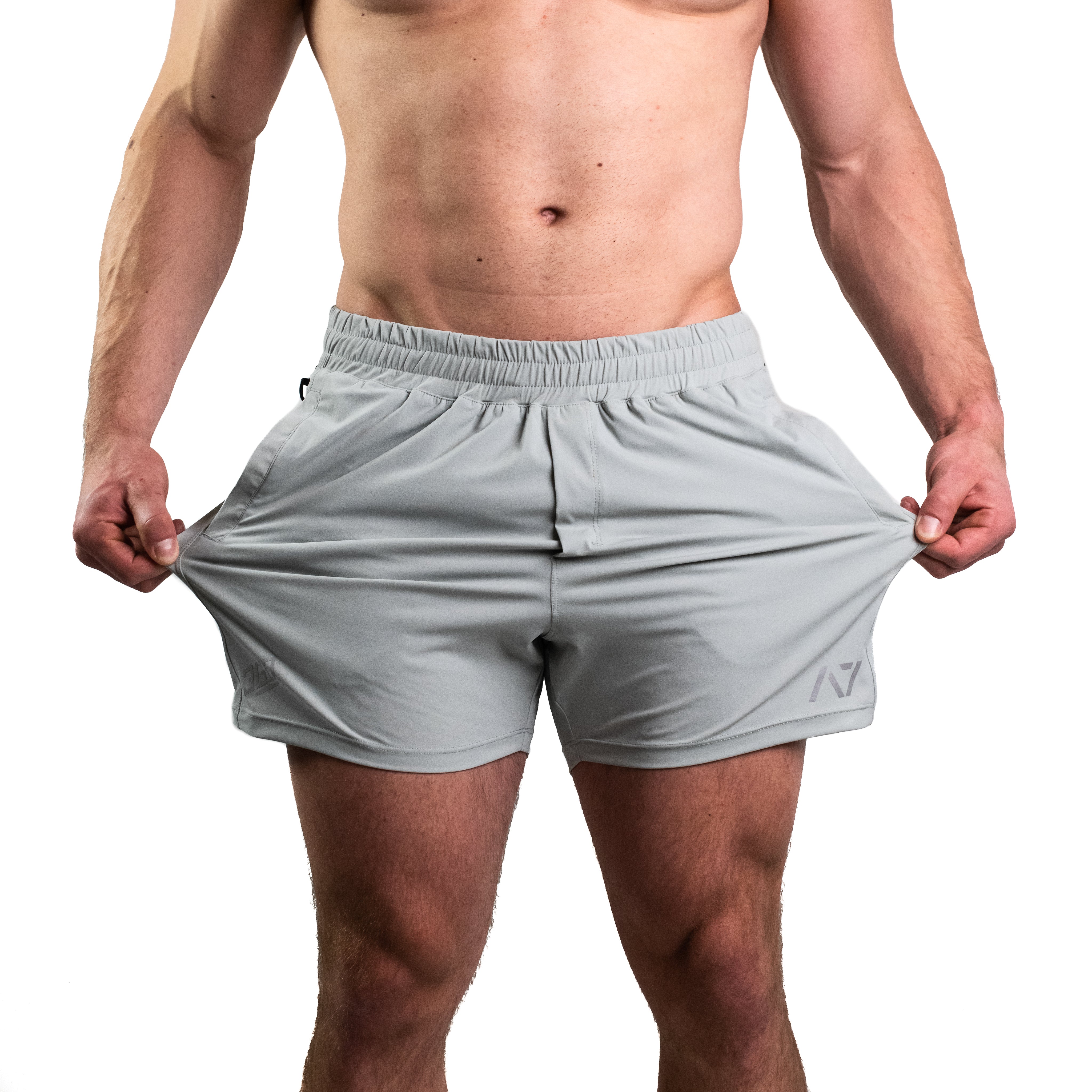 Close-up of 360-degree stretch fabric on Light Gray 360Go KWD Shorts for freedom of movement during training.