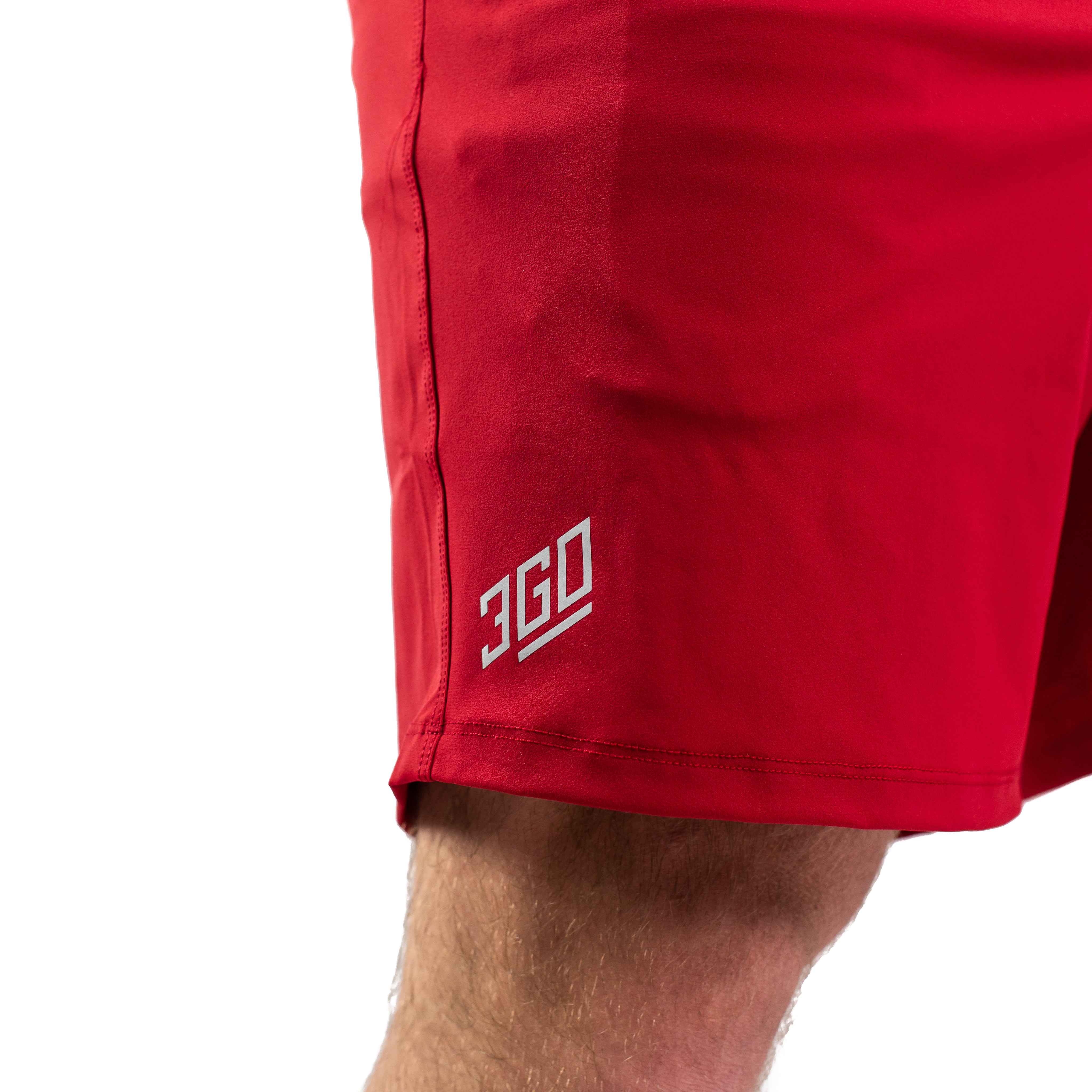 Matte silicone A7 logo on Courage 360Go Shorts for subtle branding on a bold red background.