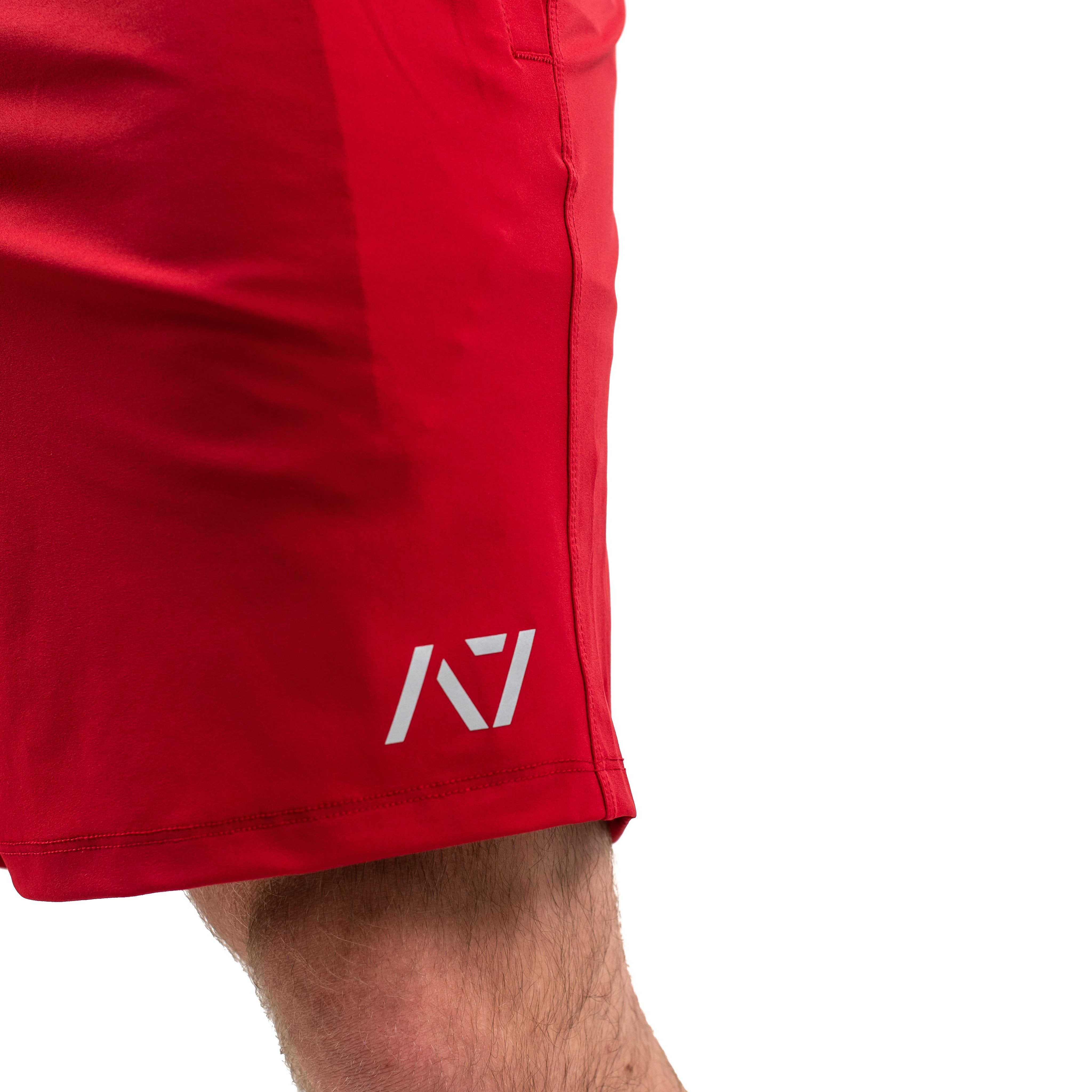 Matte silicone A7 logo on Courage 360Go Shorts for subtle branding on a bold red background.