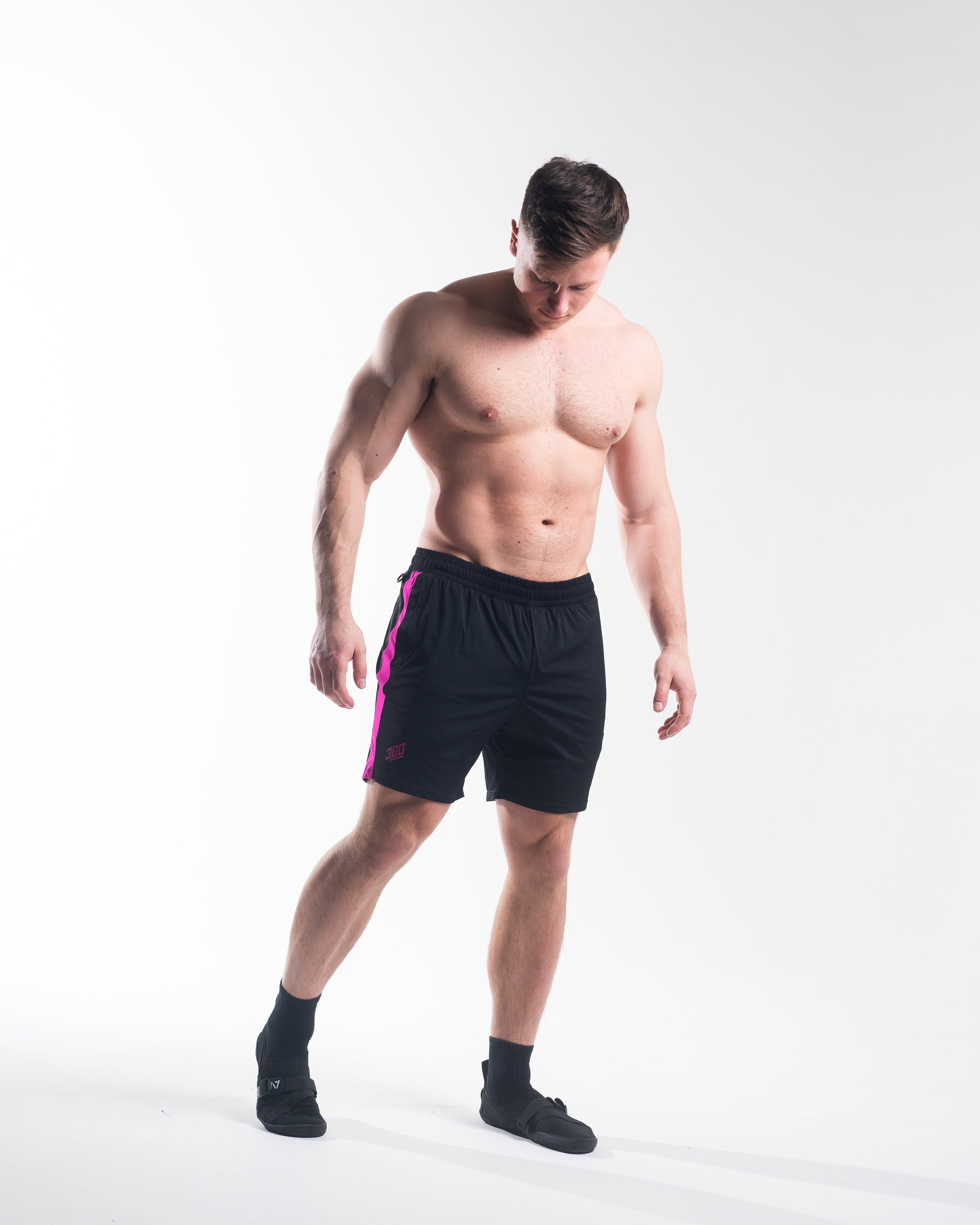 Full body image of athlete wearing A7 360Go Regular Shorts in Flamingo, highlighting color, fit, and performance use.