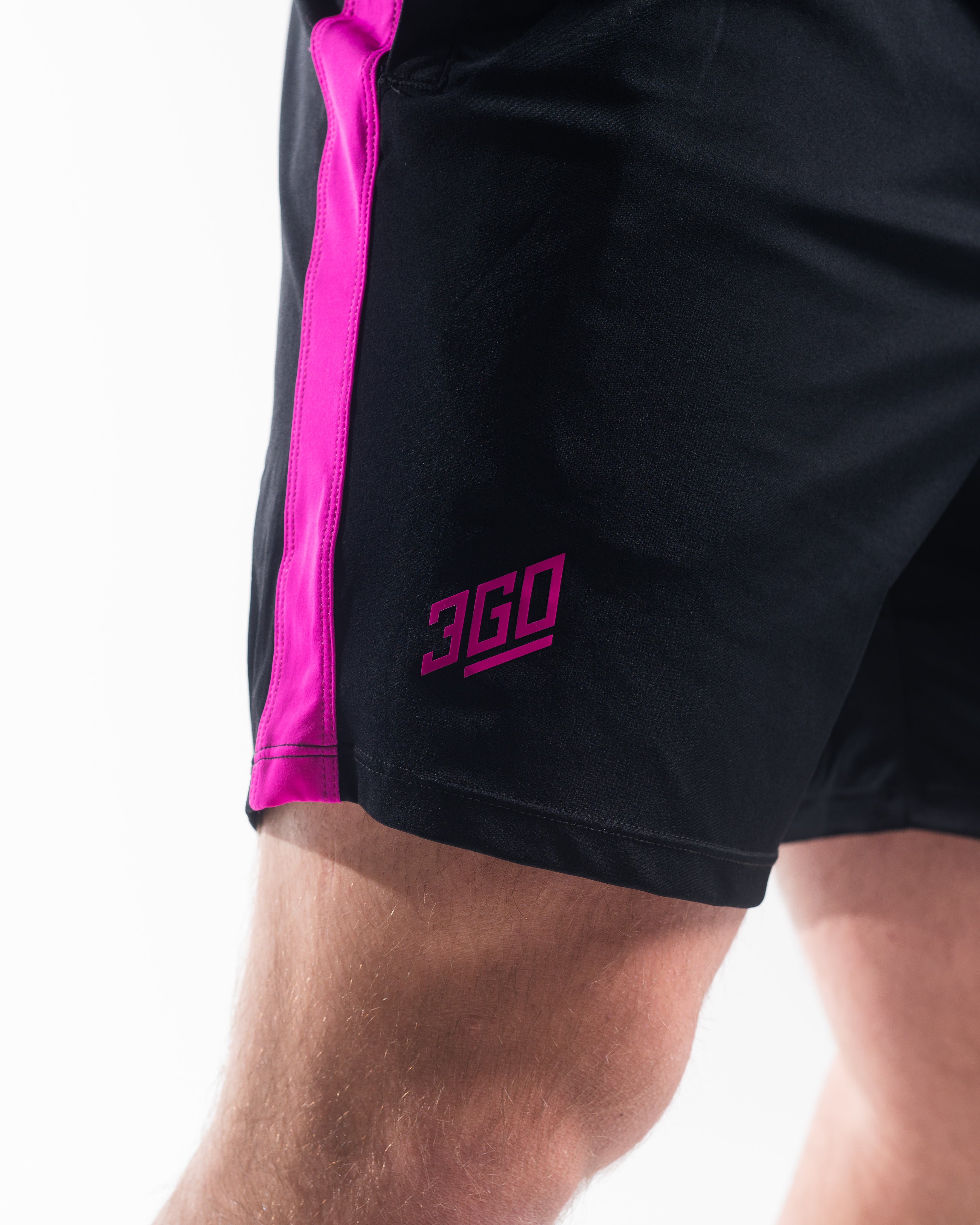 Matte silicone A7 logos on Flamingo 360Go Shorts for subtle, durable branding on a bold pink base.