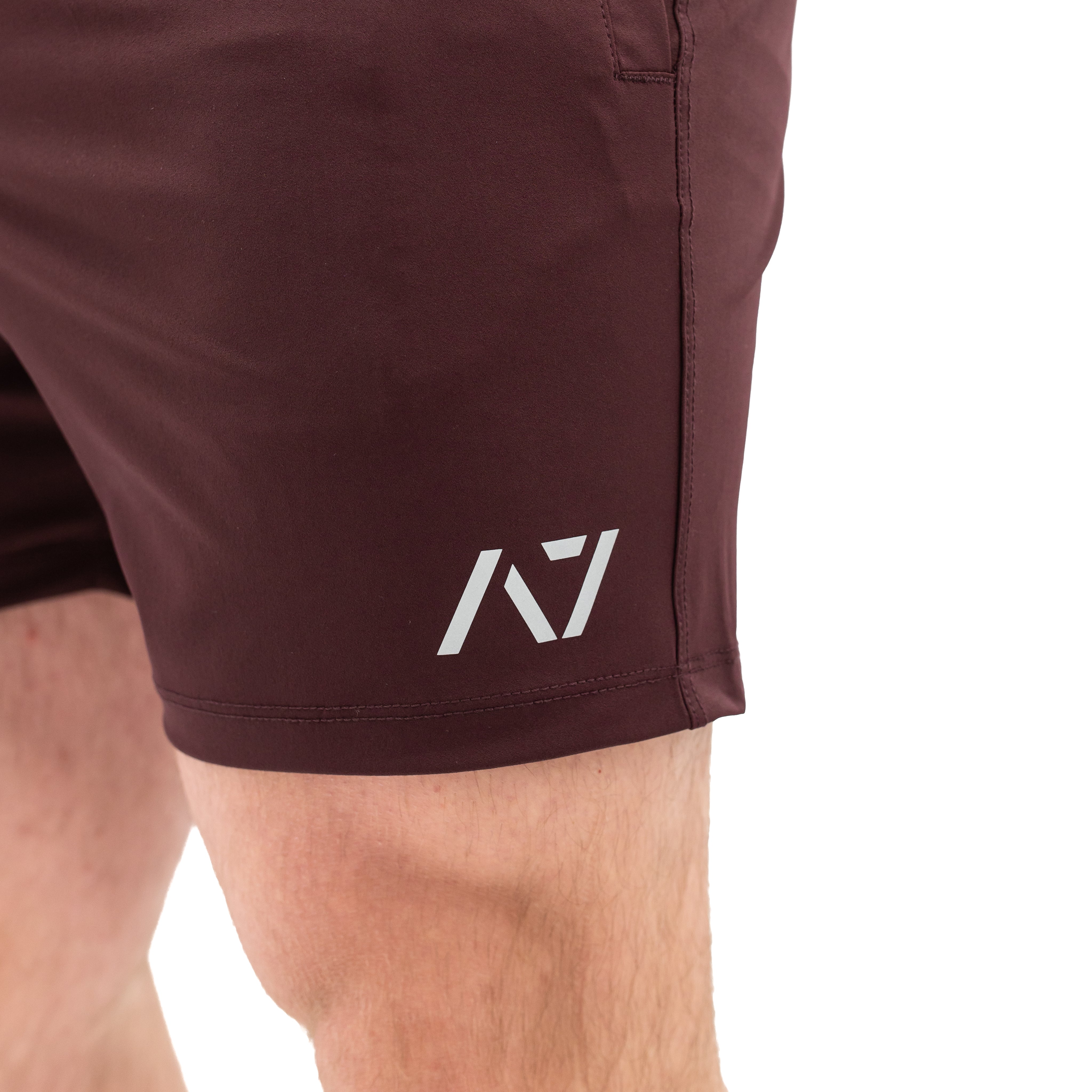 Matte silicone A7 logos on Mahogany 360Go Shorts for subtle, long-lasting branding on a rich red base.