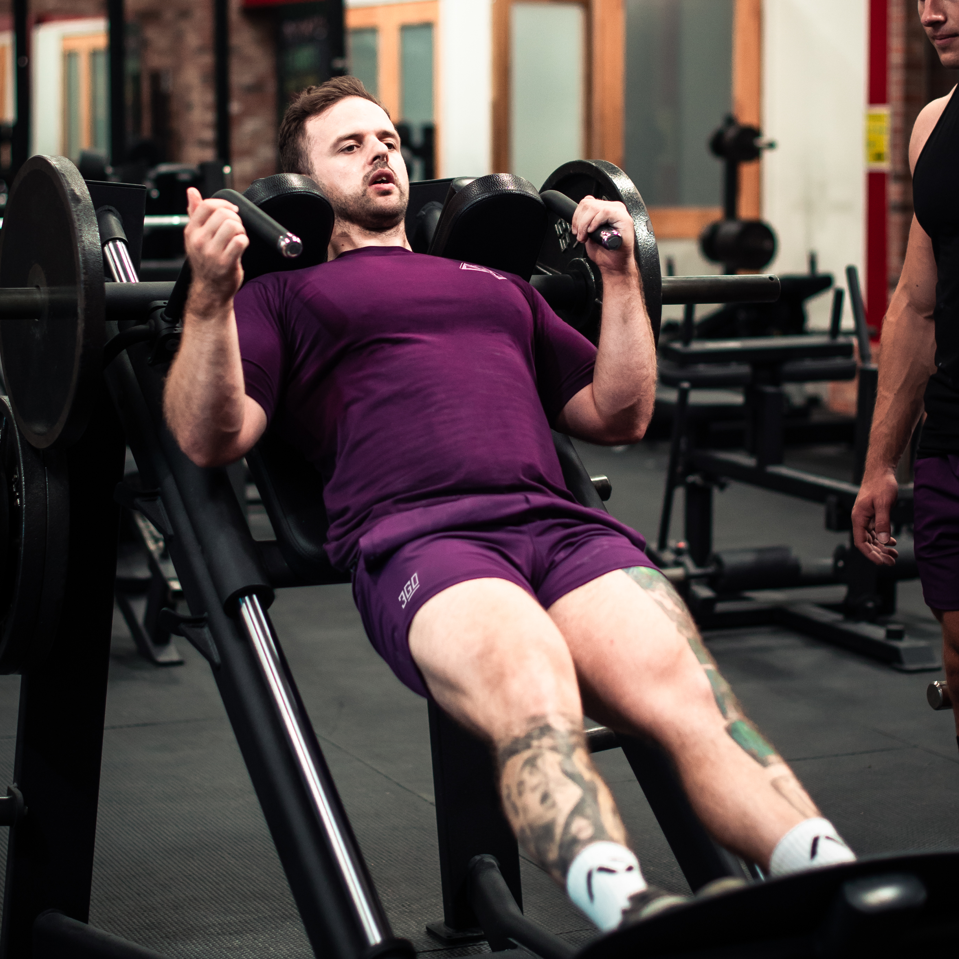 Showcasing the 360Go Shorts - Berry working with the lifter during a leg day work out.