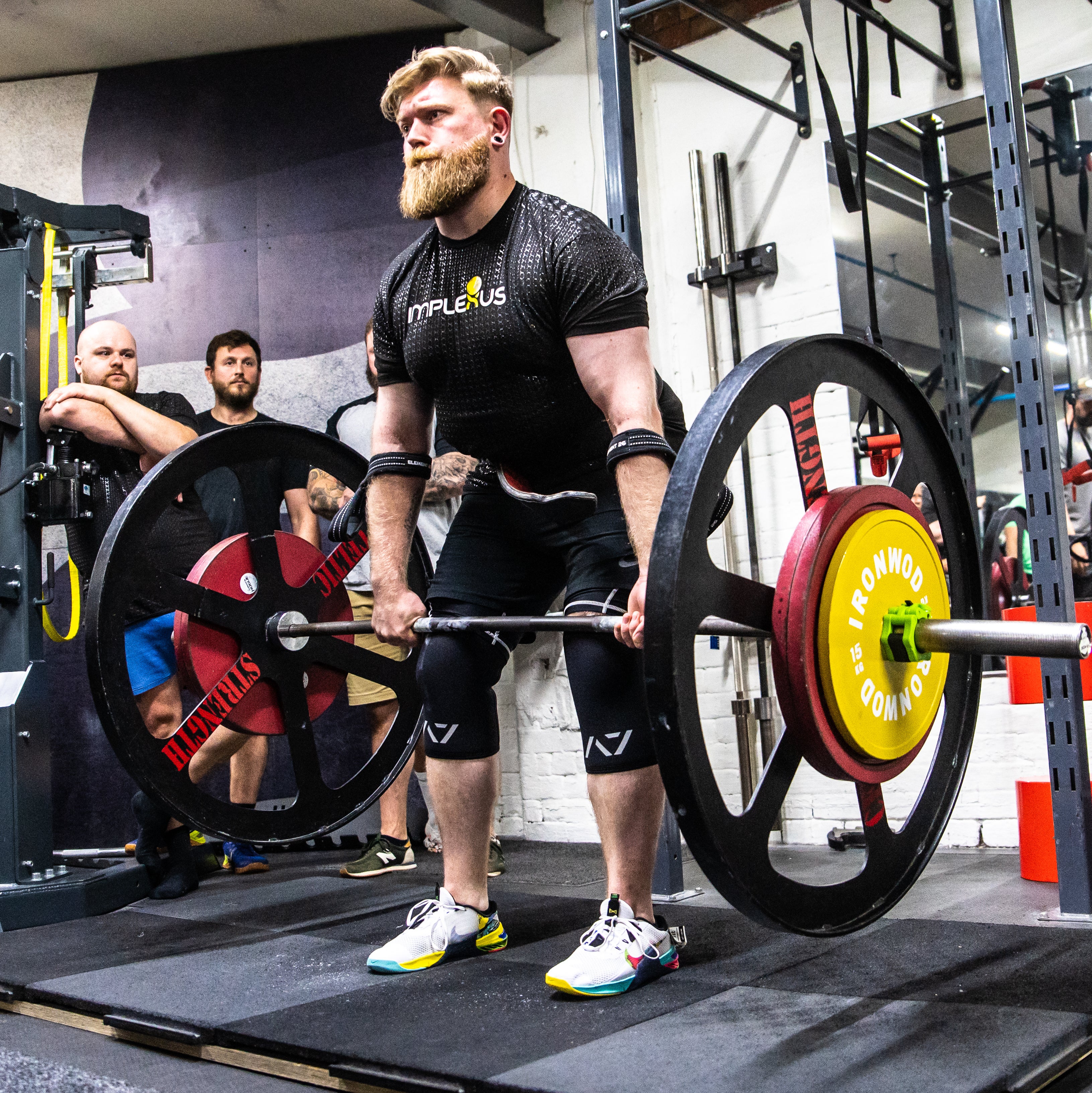 Athlete preforming deadlift with A7 Strongman Knee Sleeves – 9mm – Black/Reflective