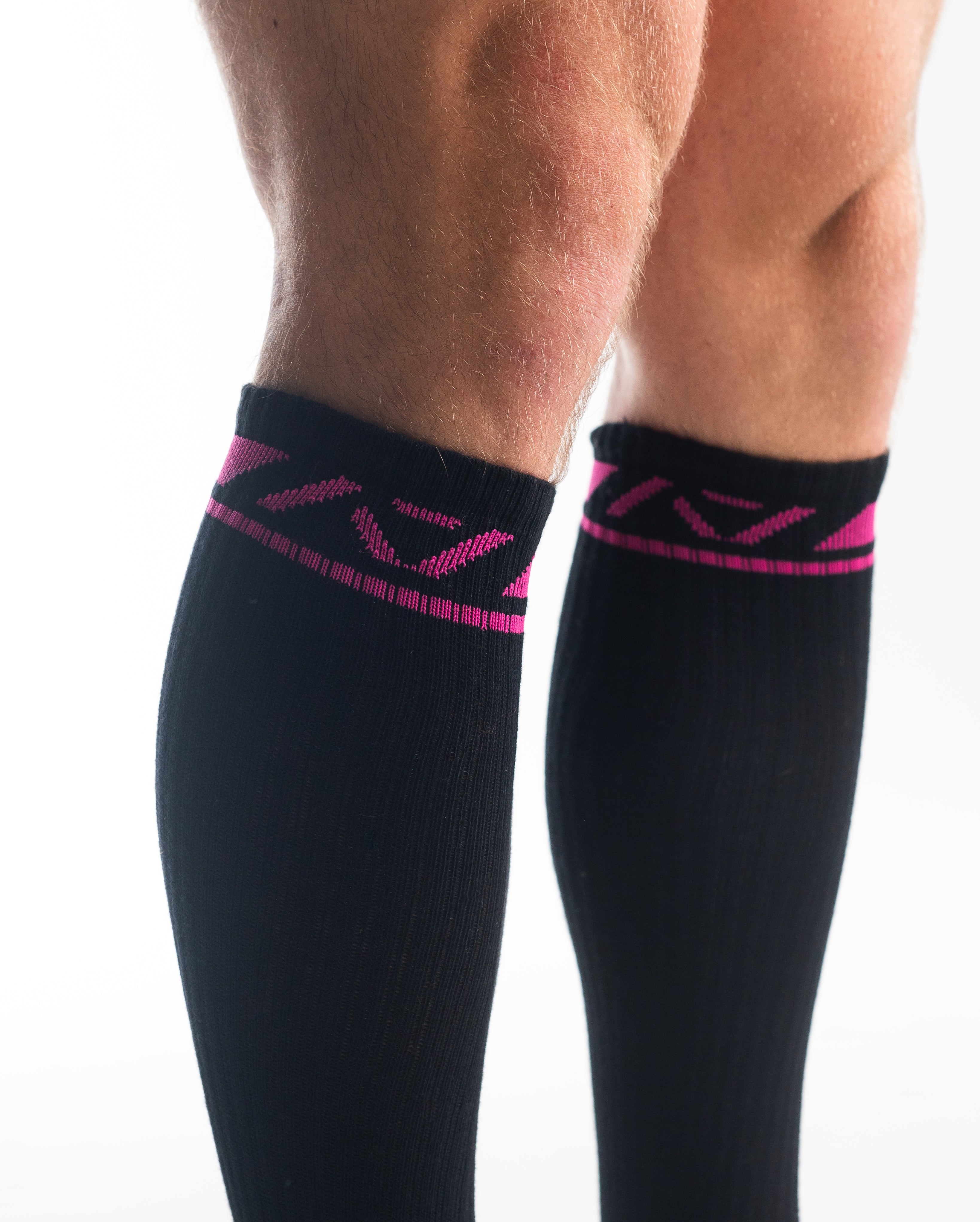 Close-up of the knit fabric on A7 Deadlift Socks in Flamingo, showing texture and stitching details.