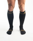 Front view of A7 Deadlift Socks in Gold Standard, showcasing knee-high length and ribbed cuff design.