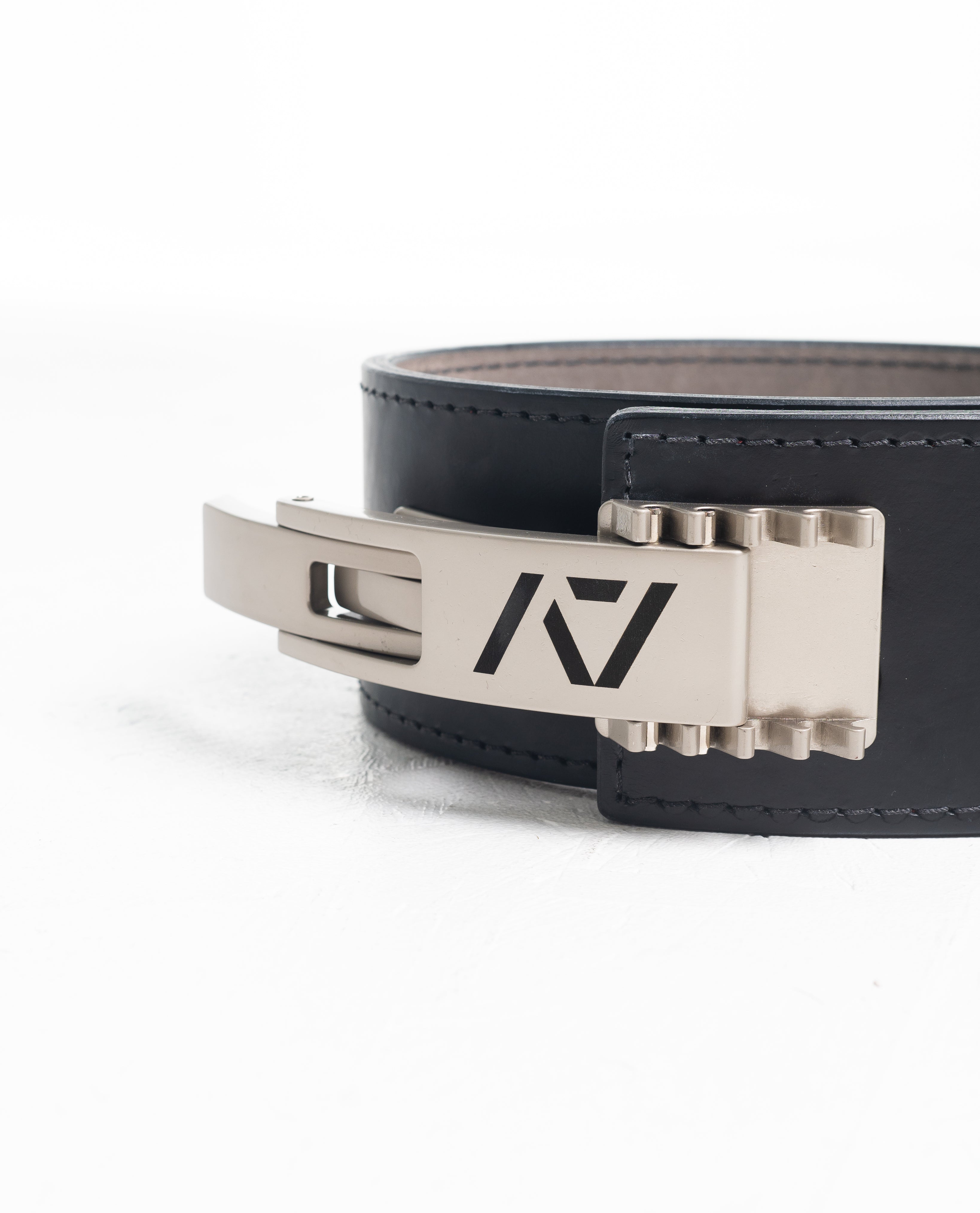 Close up of A7 PAL Buckle in silver mounted on a leather lifting belt, showing compatibility and adjustable fit.