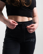 Drawstring for shadow stone defy joggers with shadow stone gray logo on left leg.