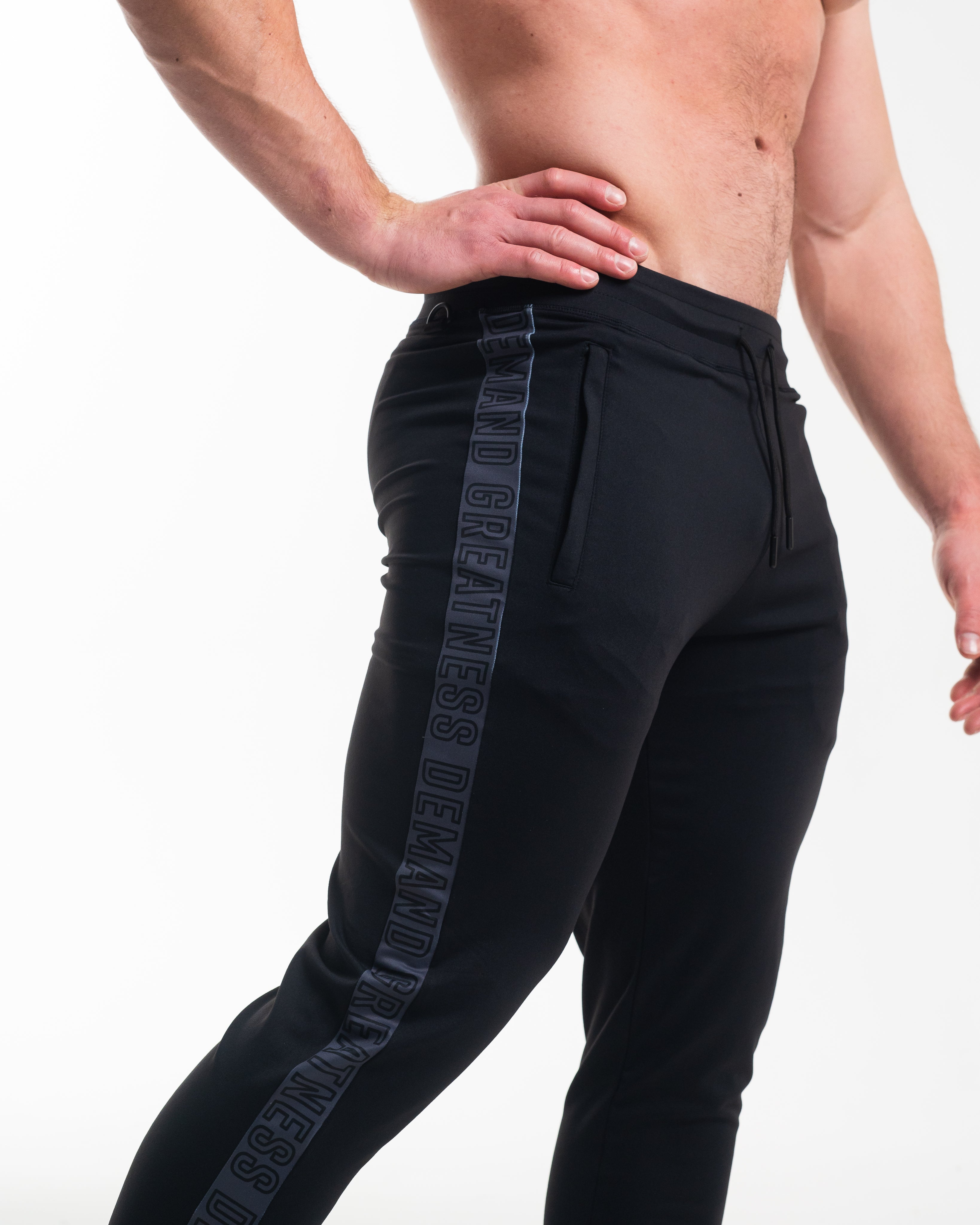 Black jogger pants with shadow stone branding on a white background