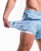 Demonstration of 360-degree stretch fabric on Slate Blue 360Go shorts, offering unrestricted movement for lifting and training.