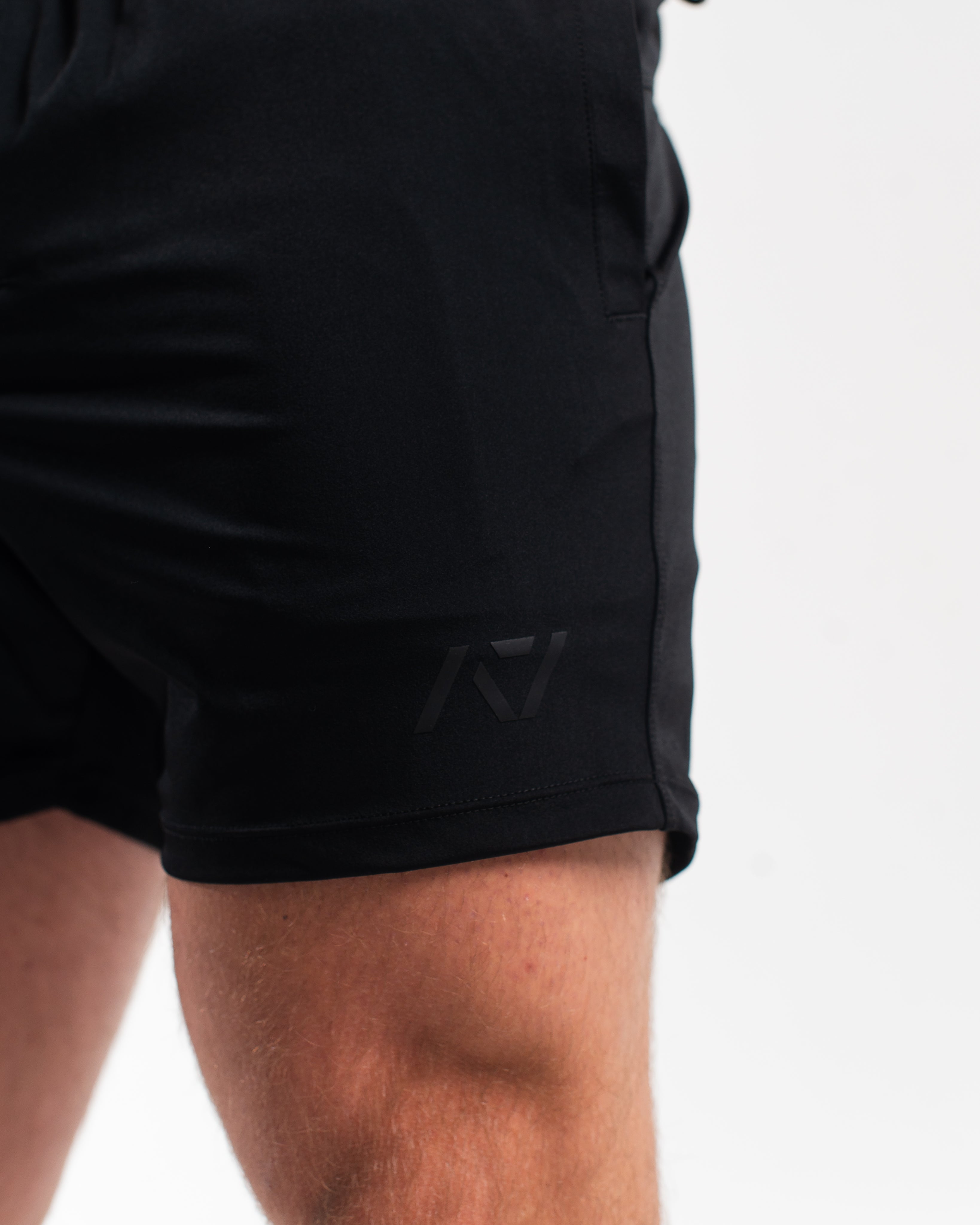 Close-up of matte black silicone A7 logo on Stealth 360Go 1Z KWD Shorts for a clean and minimal finish.