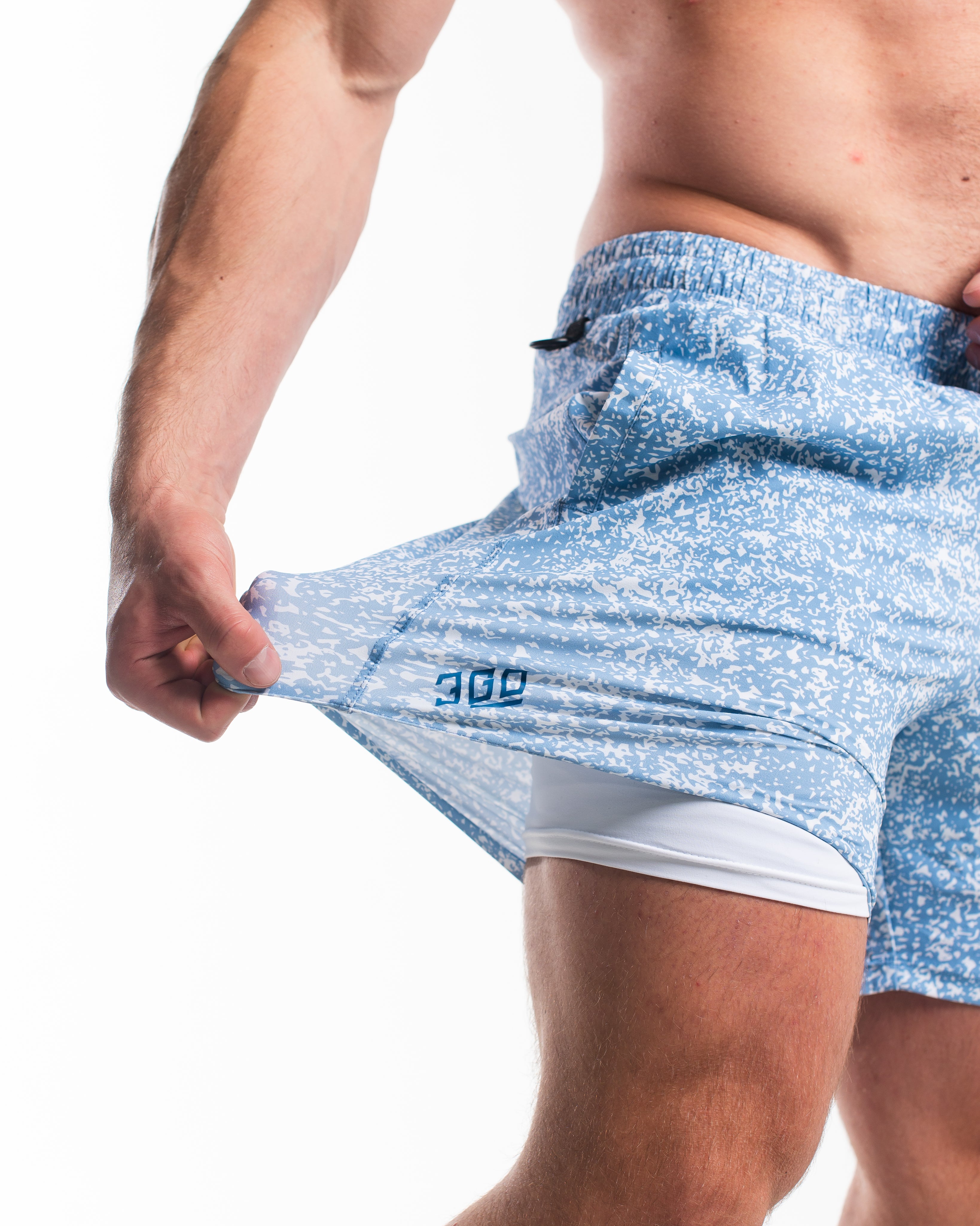 Demonstration of the flexible 360-degree stretch fabric used in A7 Slate Blue shorts for full mobility.