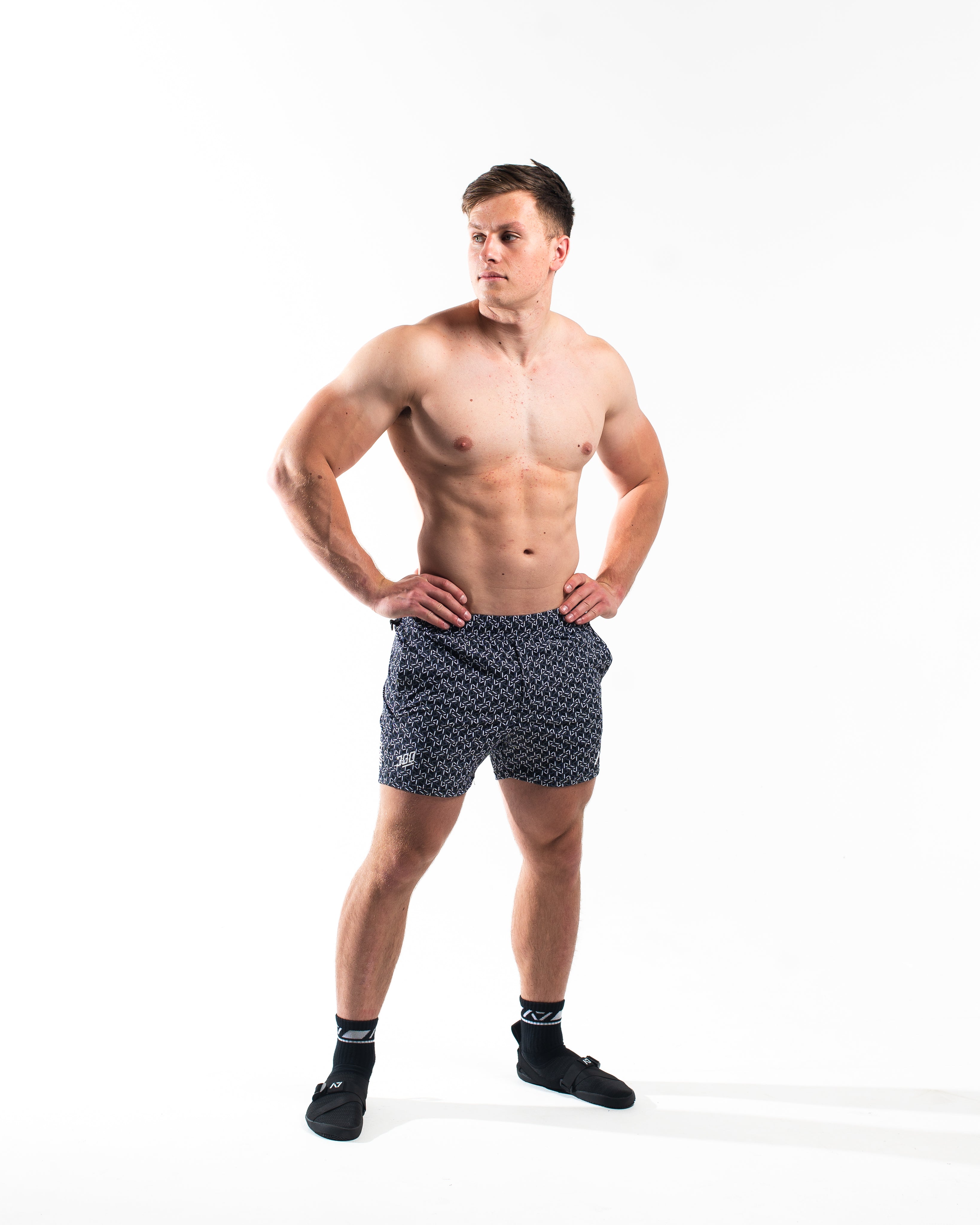 Full body view of athlete wearing A7 360Go KWD Shorts in Stelacrosha Black, showcasing premium fit and bold, all-black aesthetic.