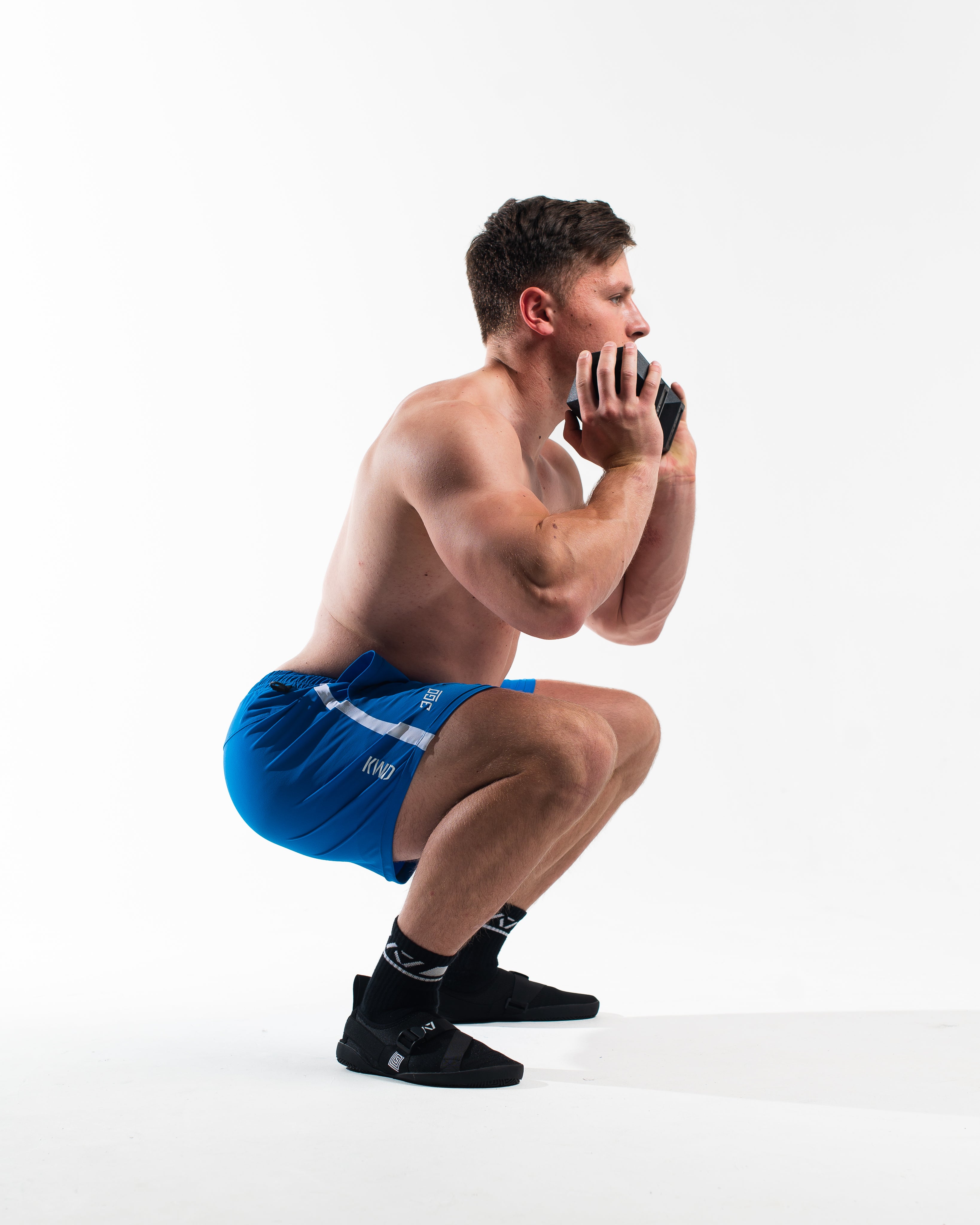 360Go Shorts in the hole of a goblet squat, showcasing the 360 degree stretch and design.