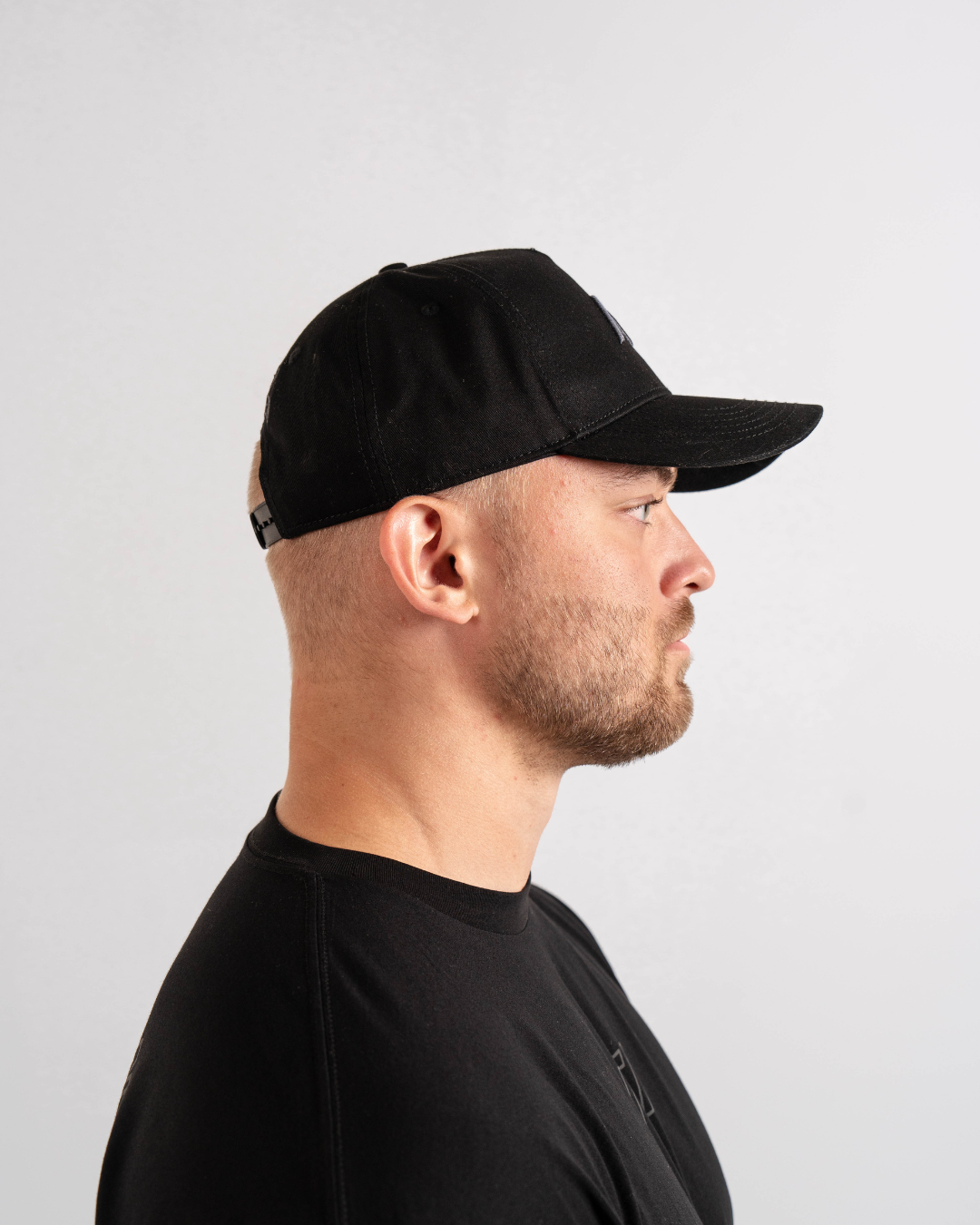 Side profile of Shadow Stone A7 snapback hat showcasing flat brim and clean tonal finish.