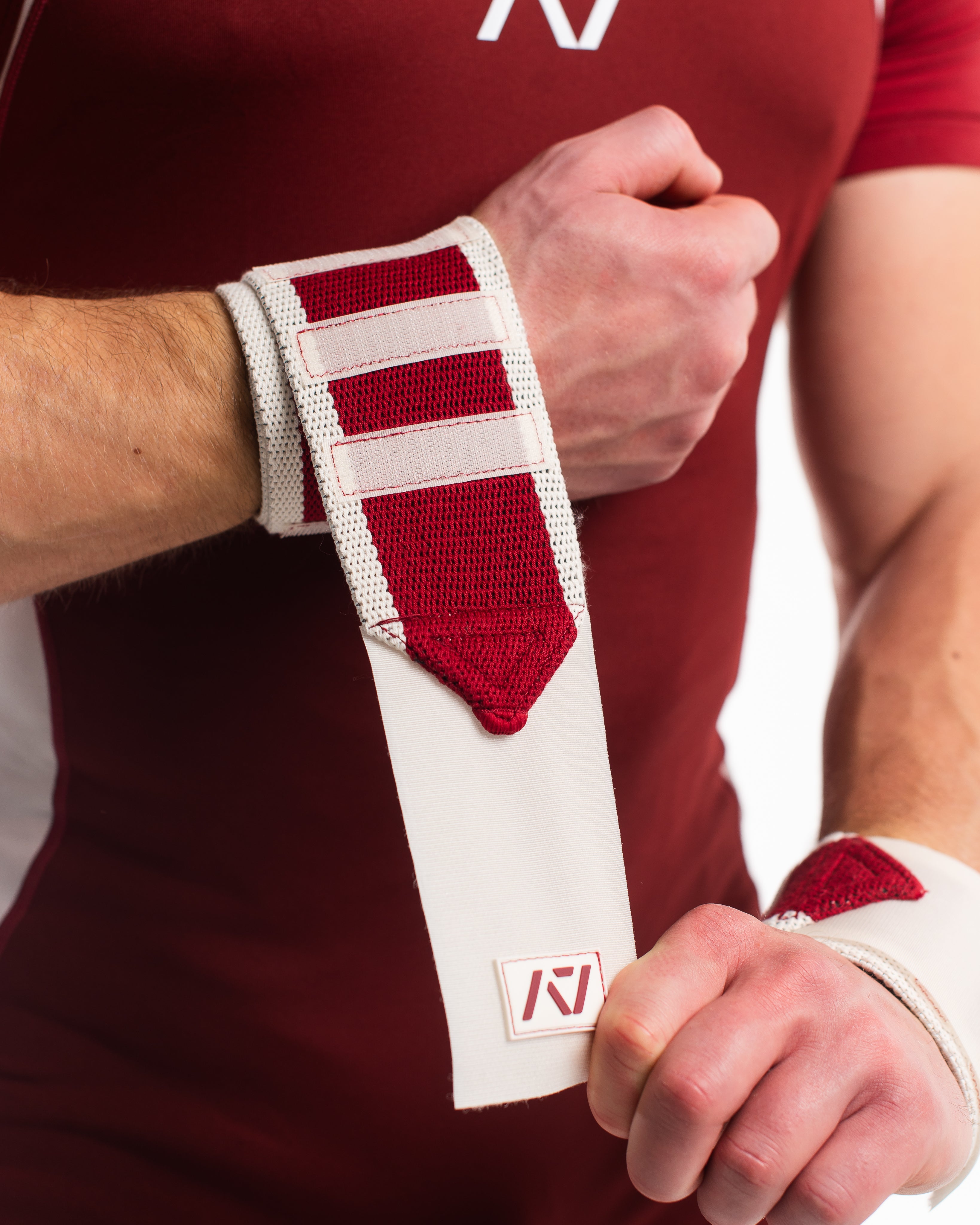 Close up of male model putting on ivory rose wrist wraps