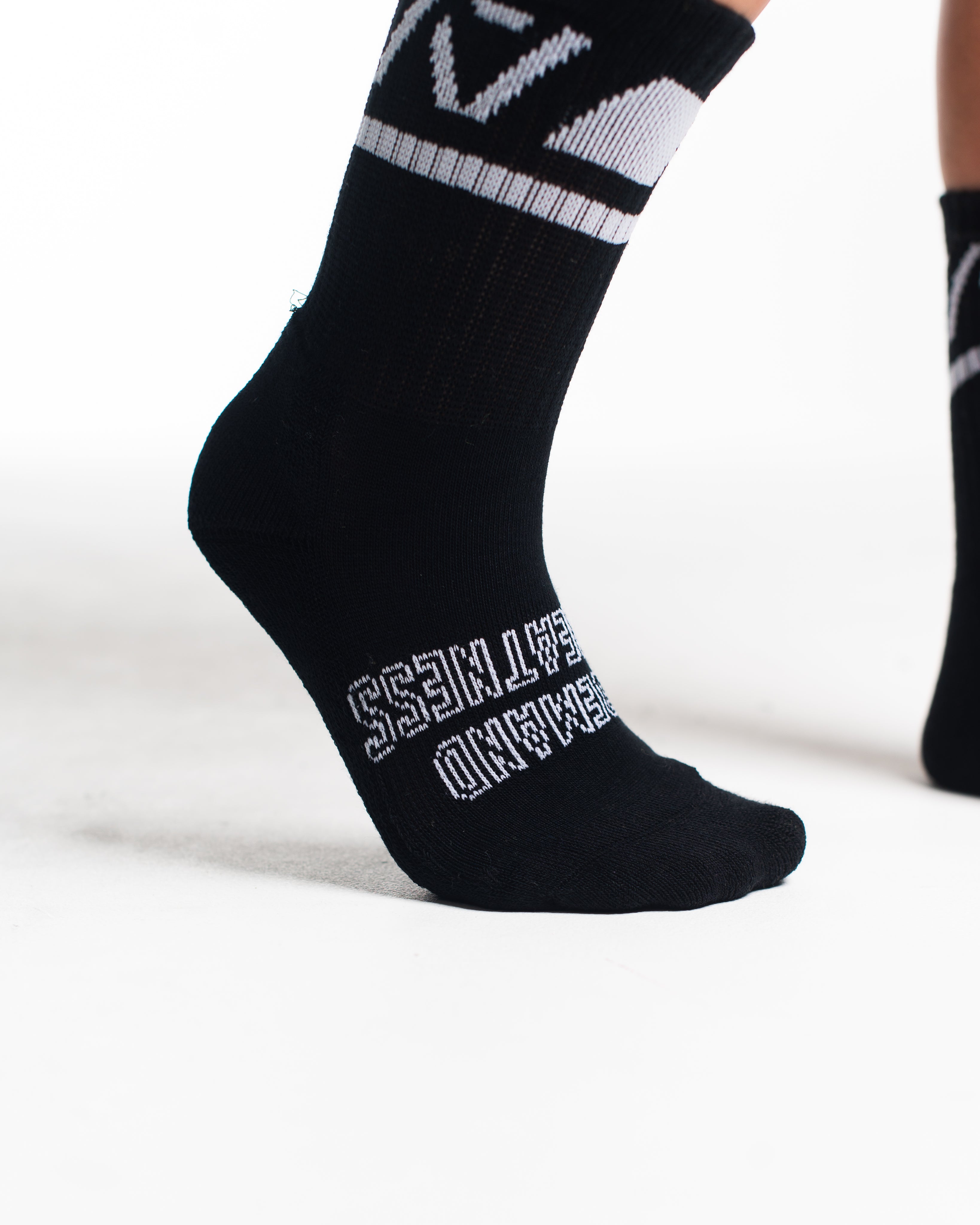 Close-up of the knit fabric on A7 Crew Socks in Black Domino, showing texture and stitching details.