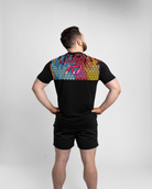 Person wearing a black t-shirt with bar grip on the back against a white background