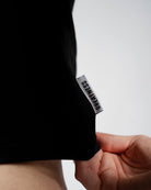 Close-up of A7 hem tag on the Affirmation True-Fit Women's Crop – Domino for added brand detail.
