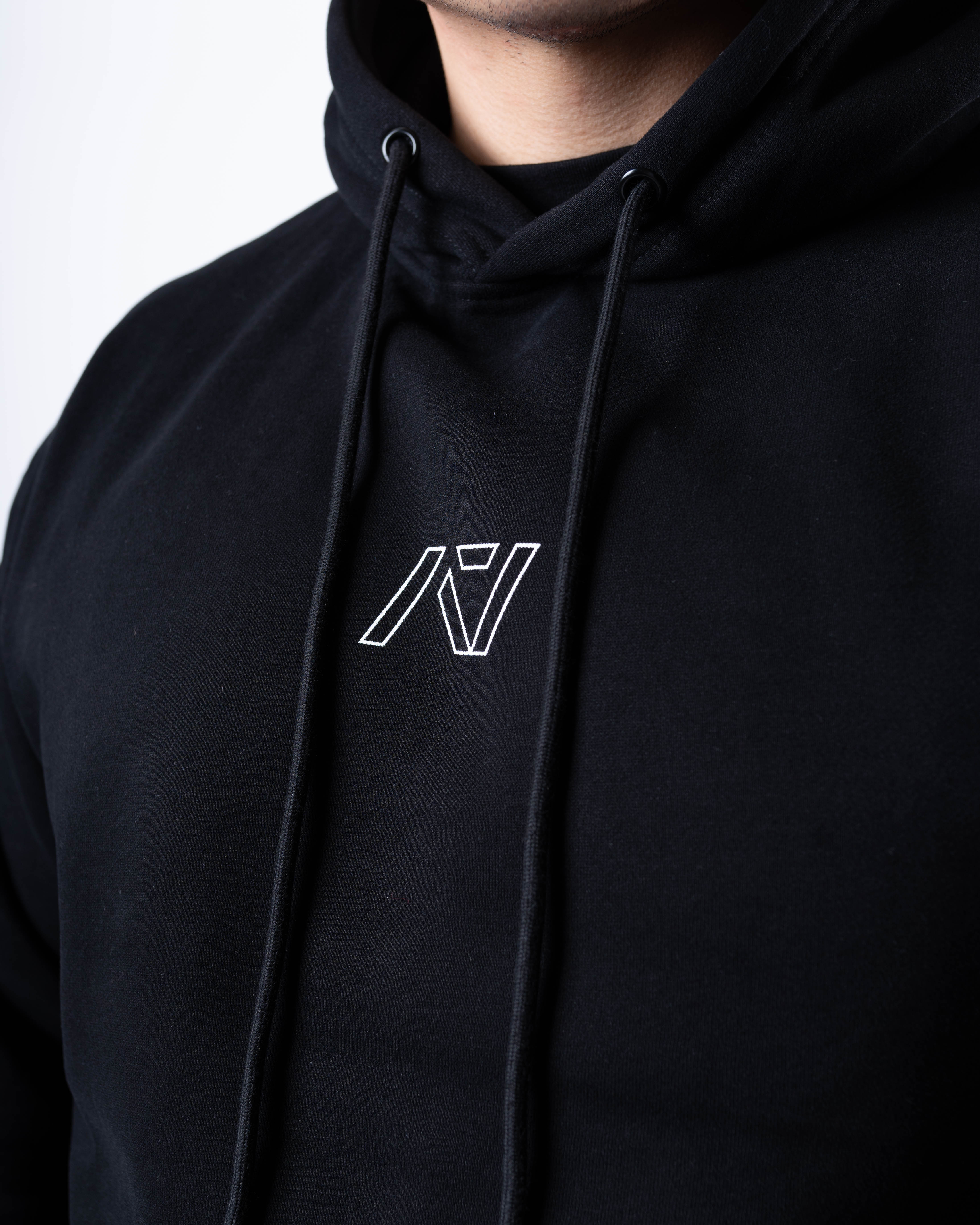 Close-up of the white A7 logo on the chest of the Built By Hoodie – Black, printed on soft fleece fabric for a clean, minimalist look.